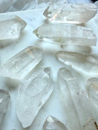 Lemurian Quartz showing textured horizontal ladder lines and natural growth striations across the crystal surface