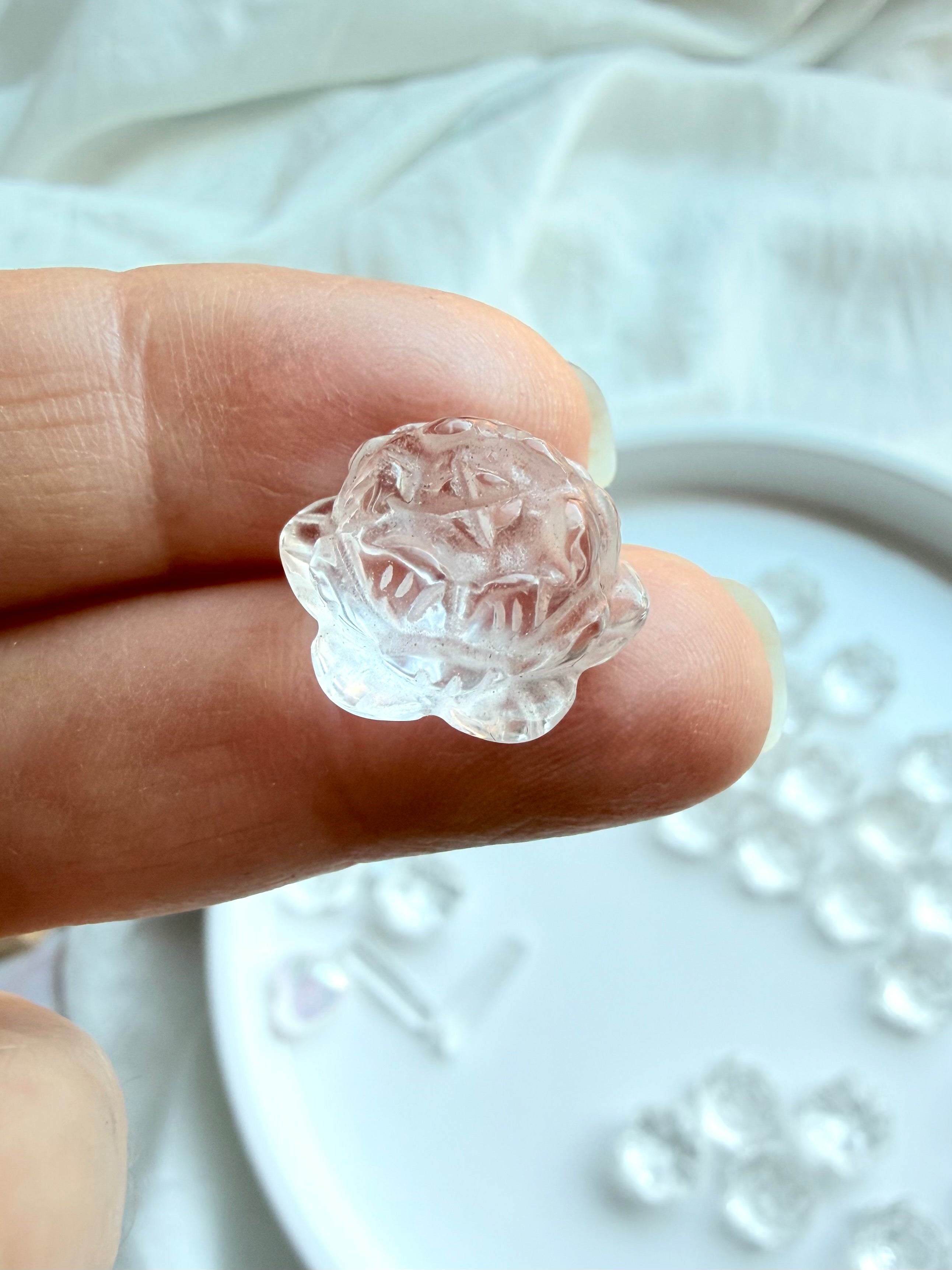 Clear Quartz mini lotus flower crystal carving, angled view with polished layered petals and natural clarity