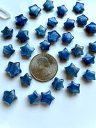 Mini Blue Kyanite star carvings shown with a US quarter for scale for meditation, energy alignment, and spiritual practice