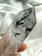 double terminated quartz crystal end detail with natural black tourmaline inclusions