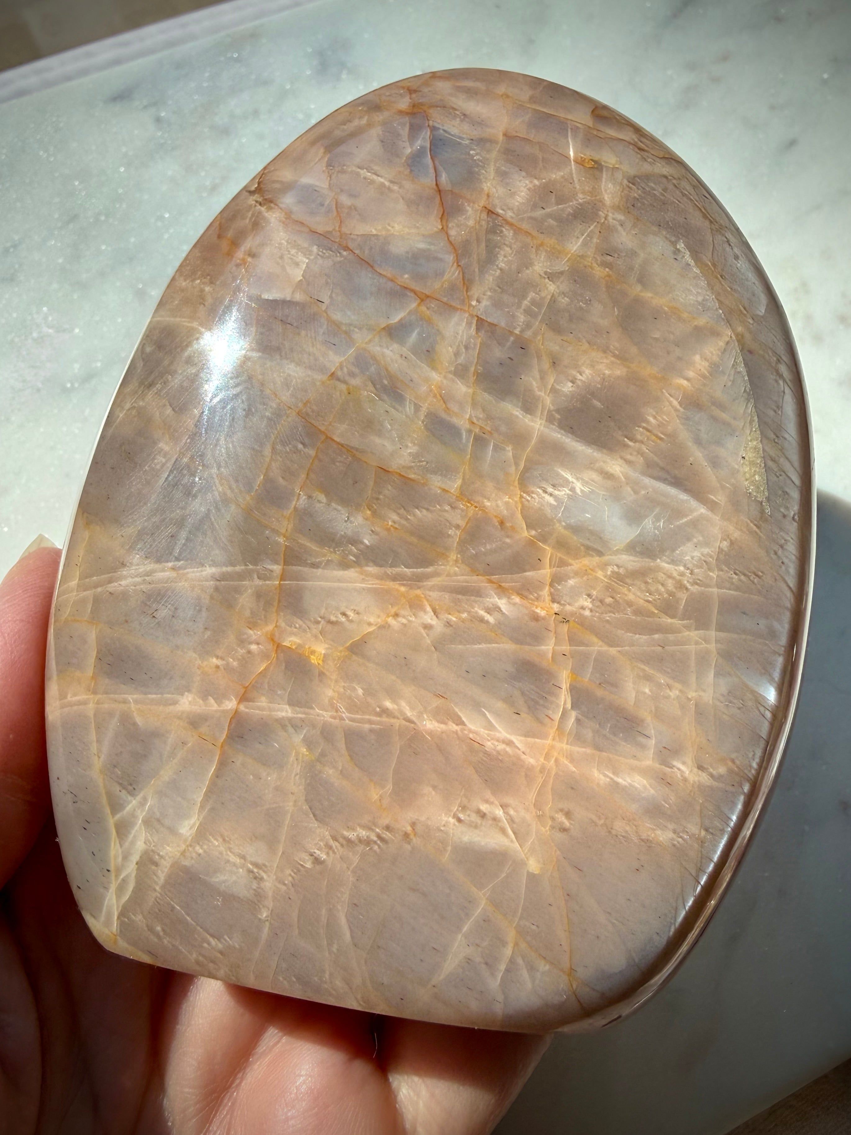 Peach Moonstone freeform reverse side showing soft silver shimmer, warm orange peach tones and natural mineral patterns