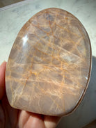 Peach Moonstone freeform reverse side showing soft silver shimmer, warm orange peach tones and natural mineral patterns