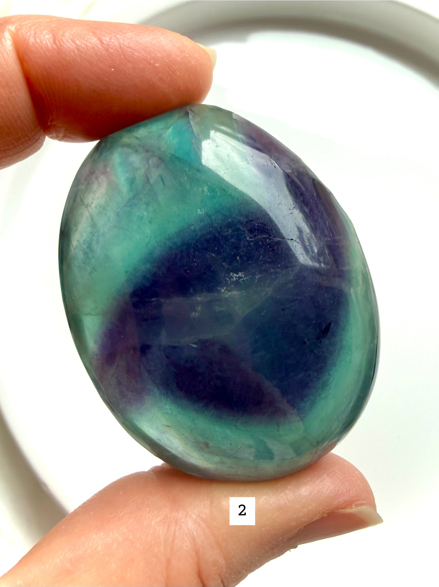 Rainbow Fluorite Palm Stone #2 with deep purple and teal bands and polished finish