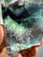 Detail view of one of a kind fluorite slab with scolecite inclusions, smooth polished face, and natural crystal patterns
