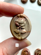 Polychrome Jasper Rose cabochon #1 held in hand showing neutral cream and tan swirls