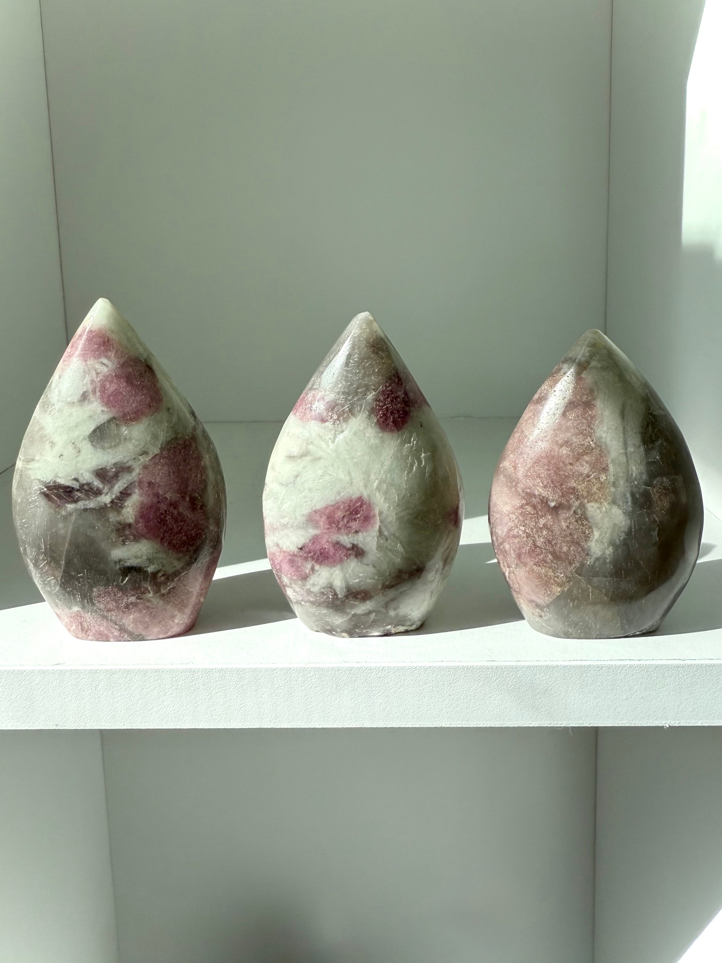 Unicorn Stone carvings in flame shapes — rare gemstone with pink tourmaline and lepidolite inclusions