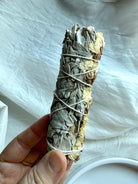 Side view of our ethically sourced white sage bundle with white statice flower for sacred smudging practice