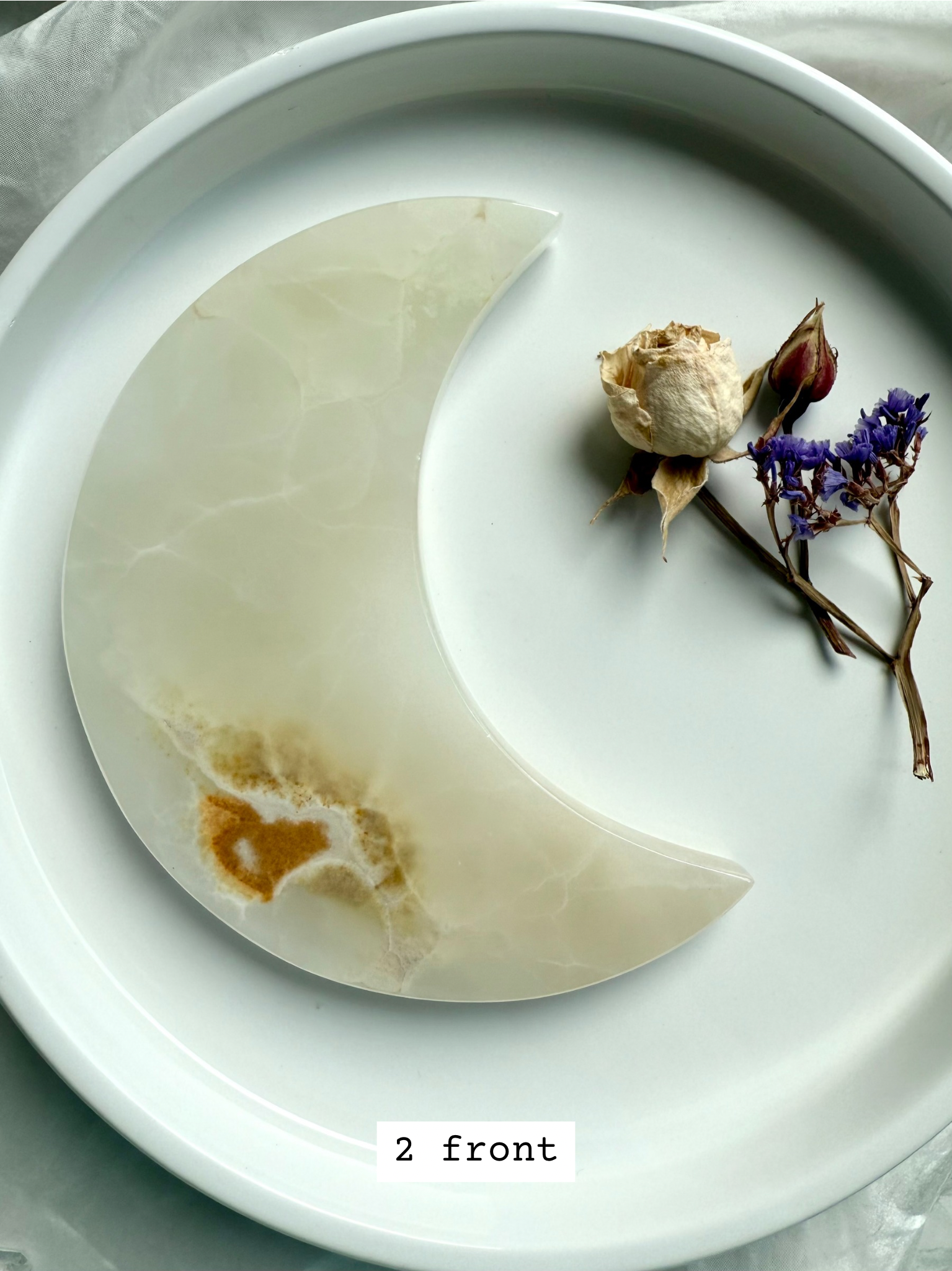 White Onyx Crescent Moon Plate, translucent ivory with golden honey inclusions, front view.