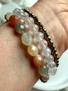 Faceted Moonstone bracelet stacked with Faceted Pyrite and White Moonstone bracelets, featuring shimmering multicolor gemstones and contrasting textures