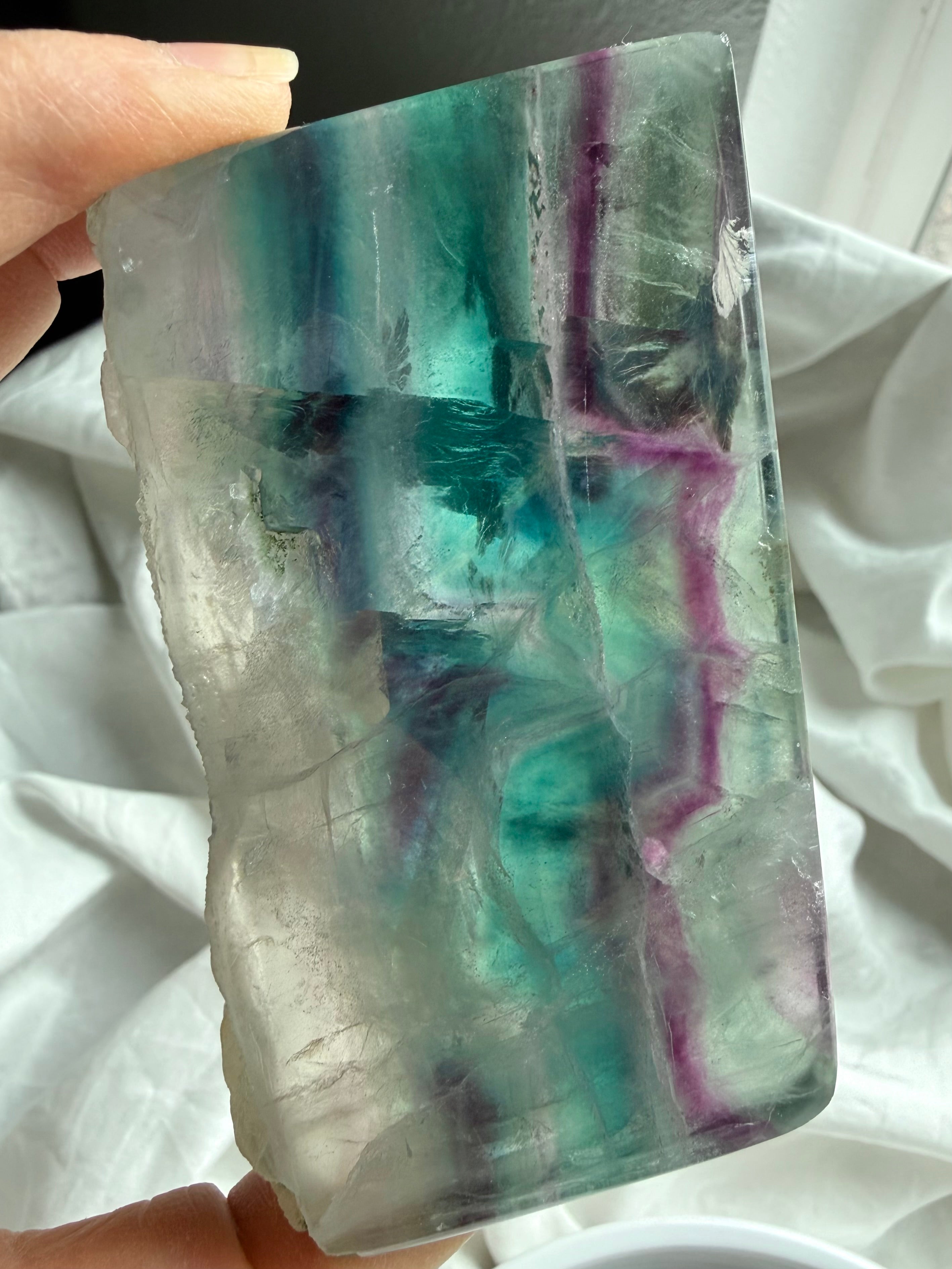 One of a kind fluorite slab shown in hand for size reference