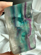 One of a kind fluorite slab shown in hand for size reference