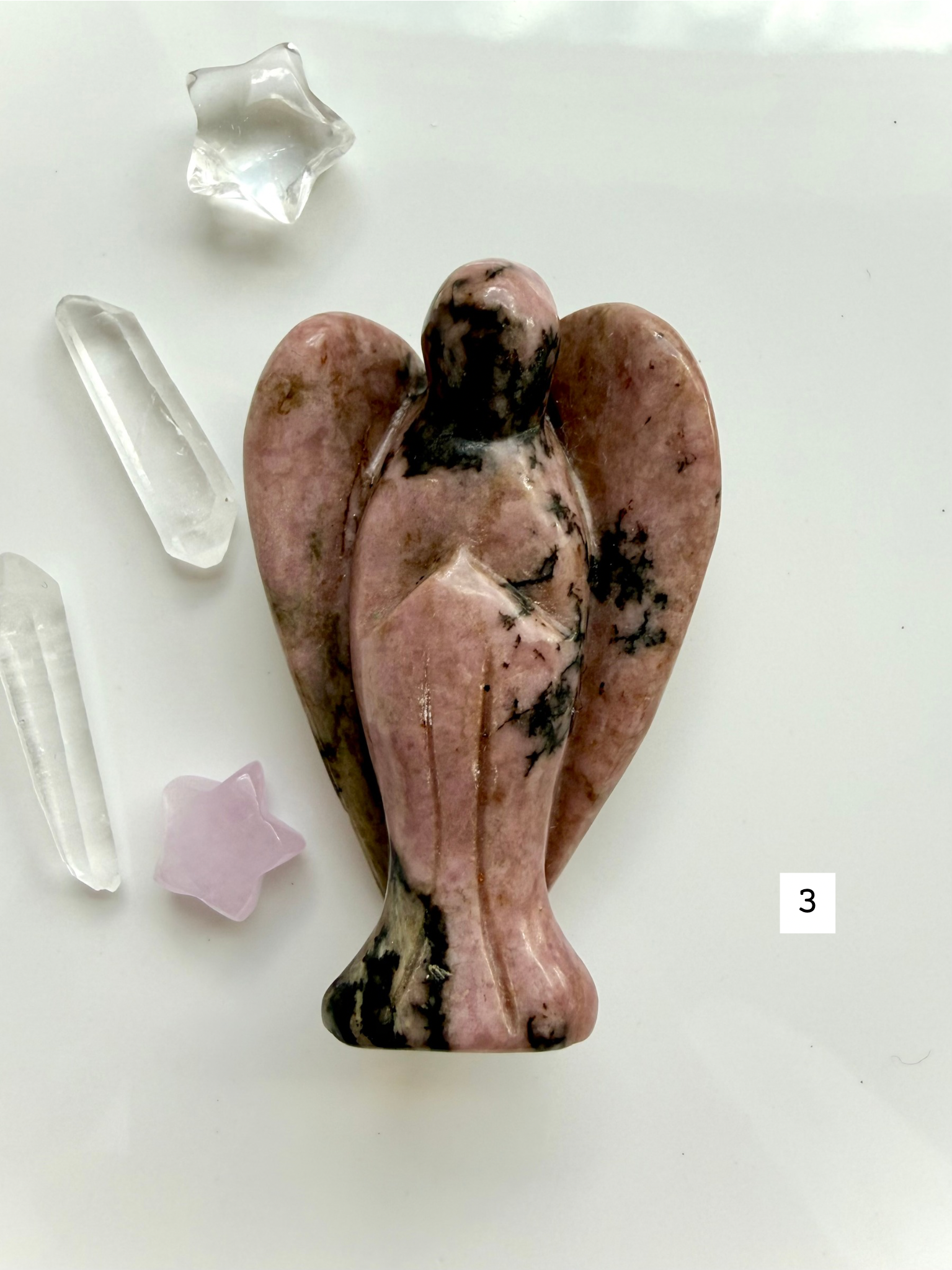 Natural Rhodonite crystal guardian angel with rosy coloring and polished wings for emotional balance
