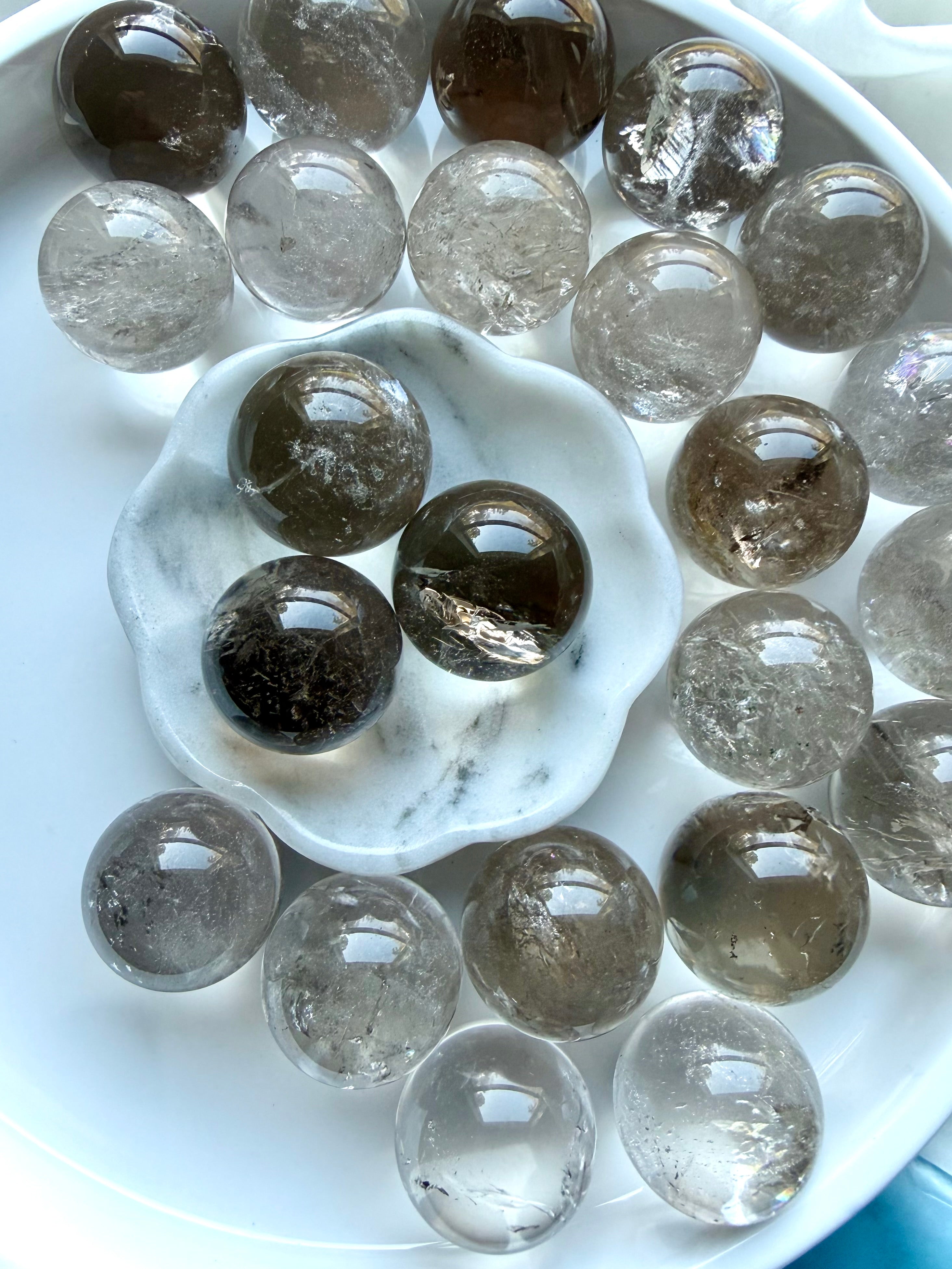 Overhead view of Smoky Quartz mini crystal spheres with glossy polish and natural color variation