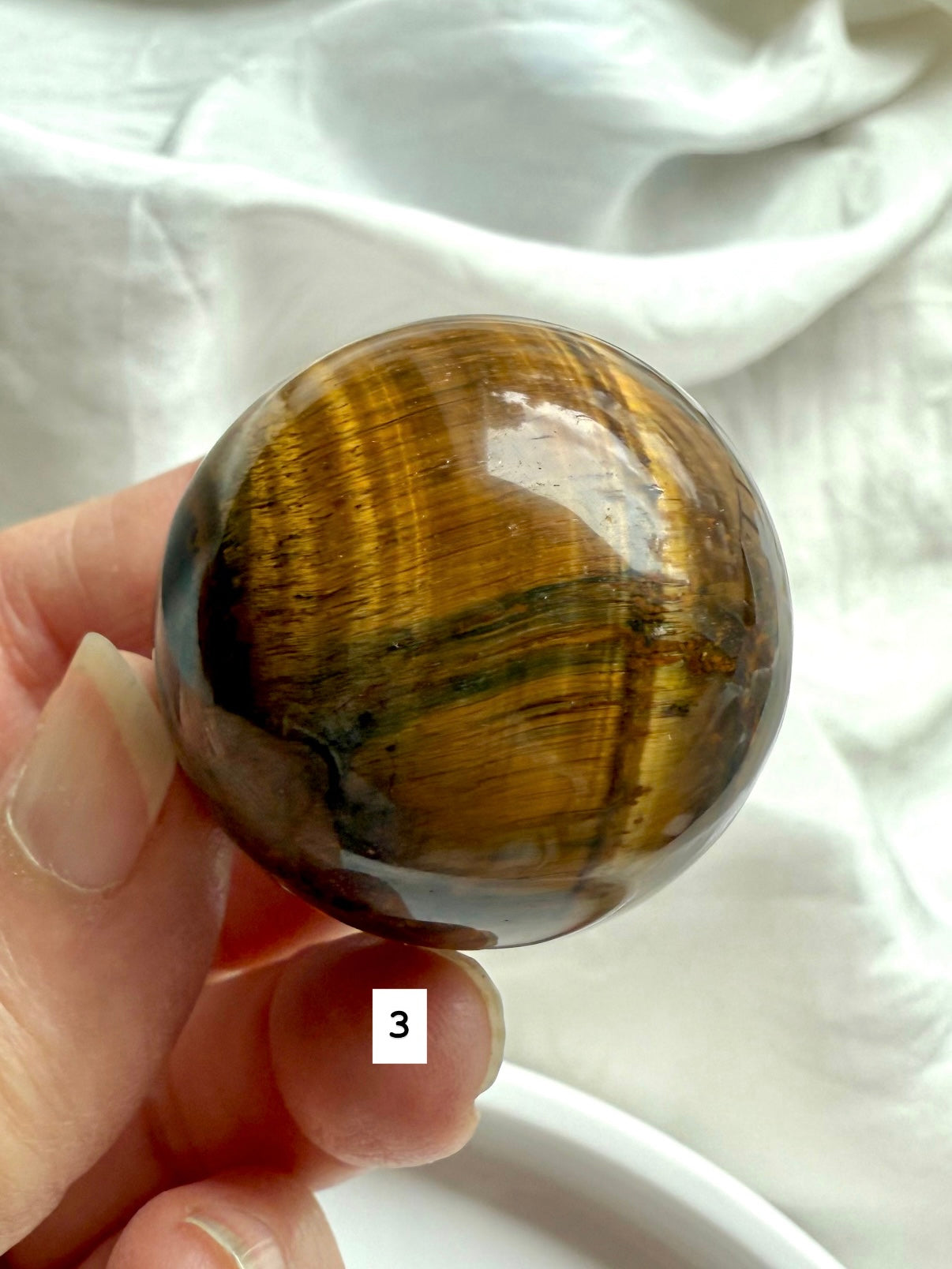 Tiger’s Eye Sphere #3 – close-up of shimmering Tiger’s Eye with warm earthy tones & focus energy