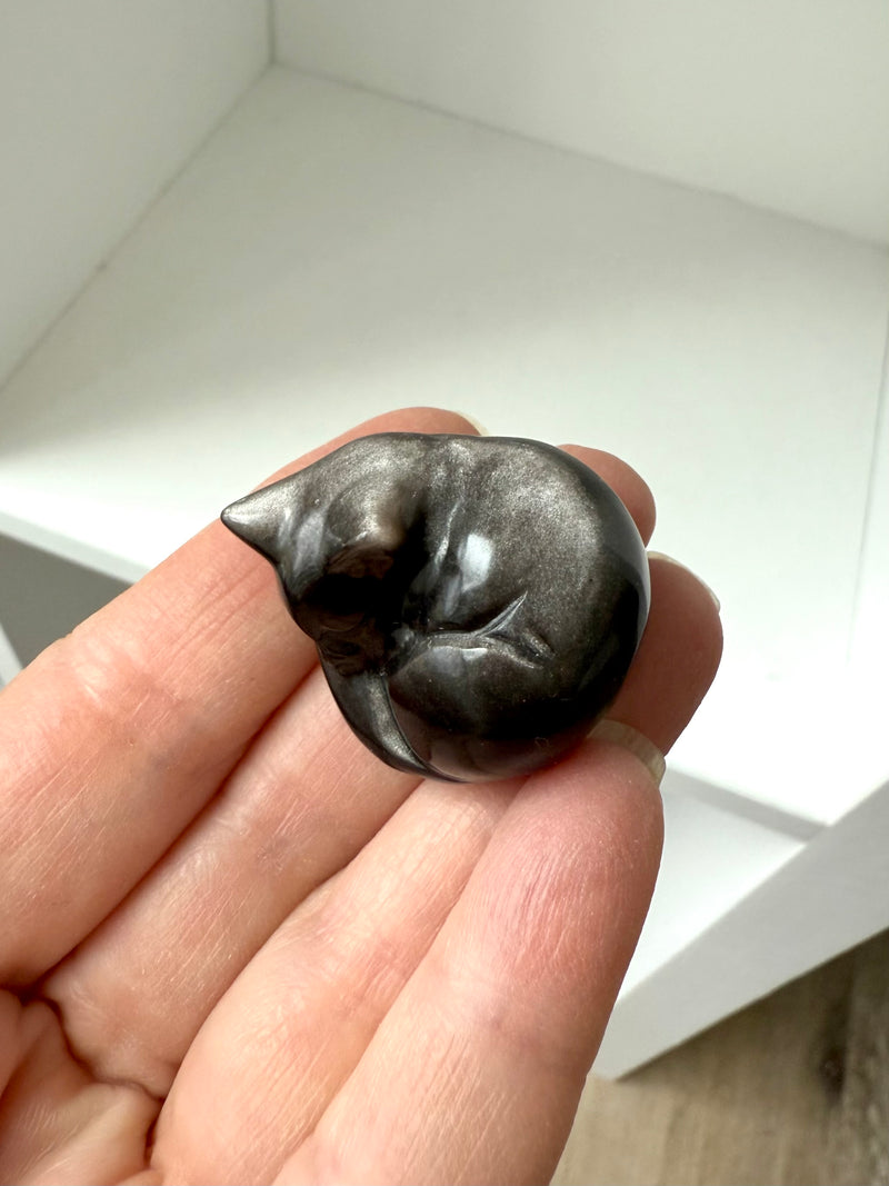 This tiny Silver Sheen Obsidian Sleeping Cat offers energetic protection to your sacred space. 