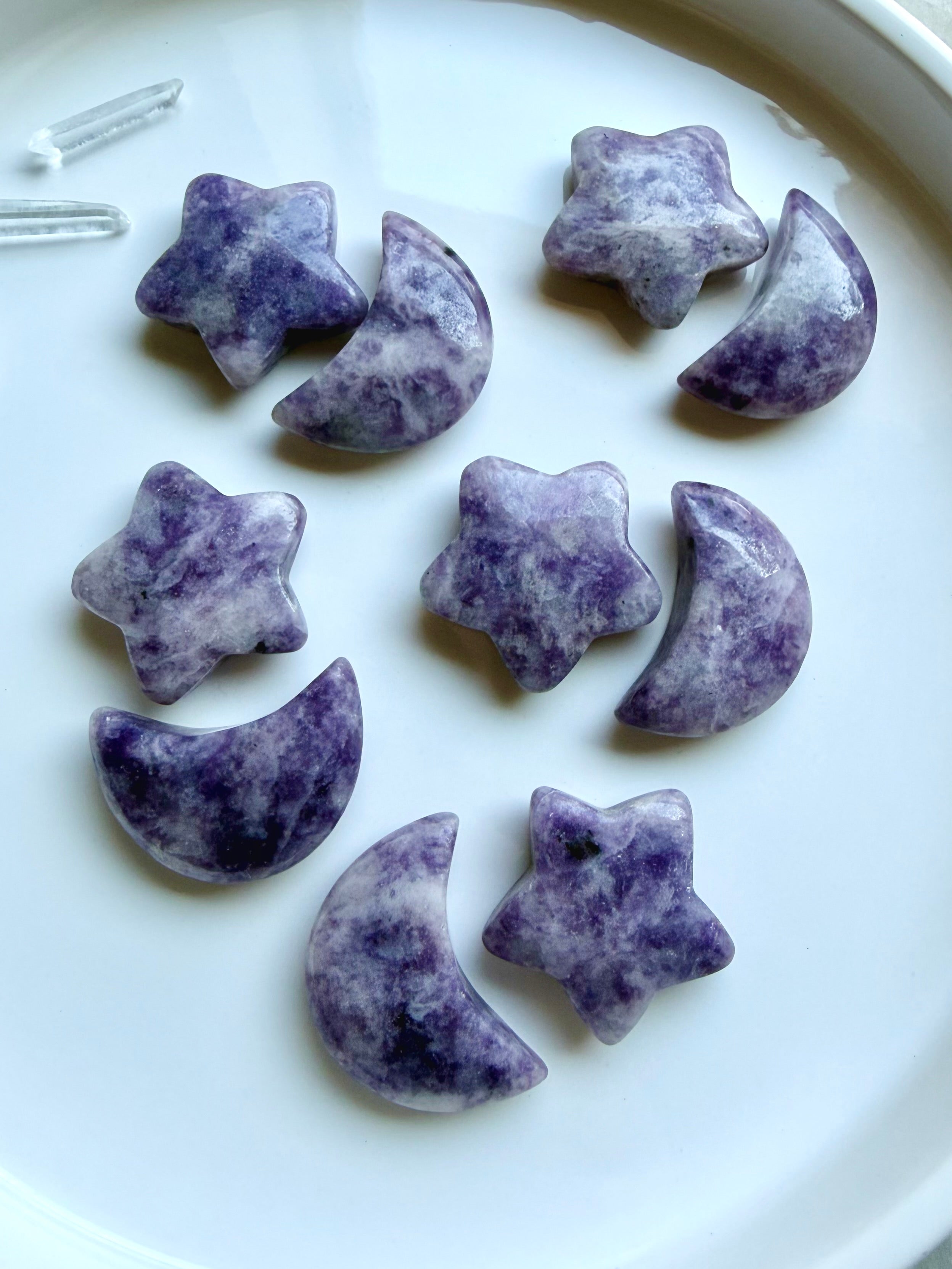 Purple Lepidolite crescent moons and stars displayed together as calming crystals for peaceful transitions and emotional healing