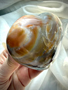 Close up Ocean Jasper heart showing layered agate banding, druzy inclusions and earthy green sea jasper patterning