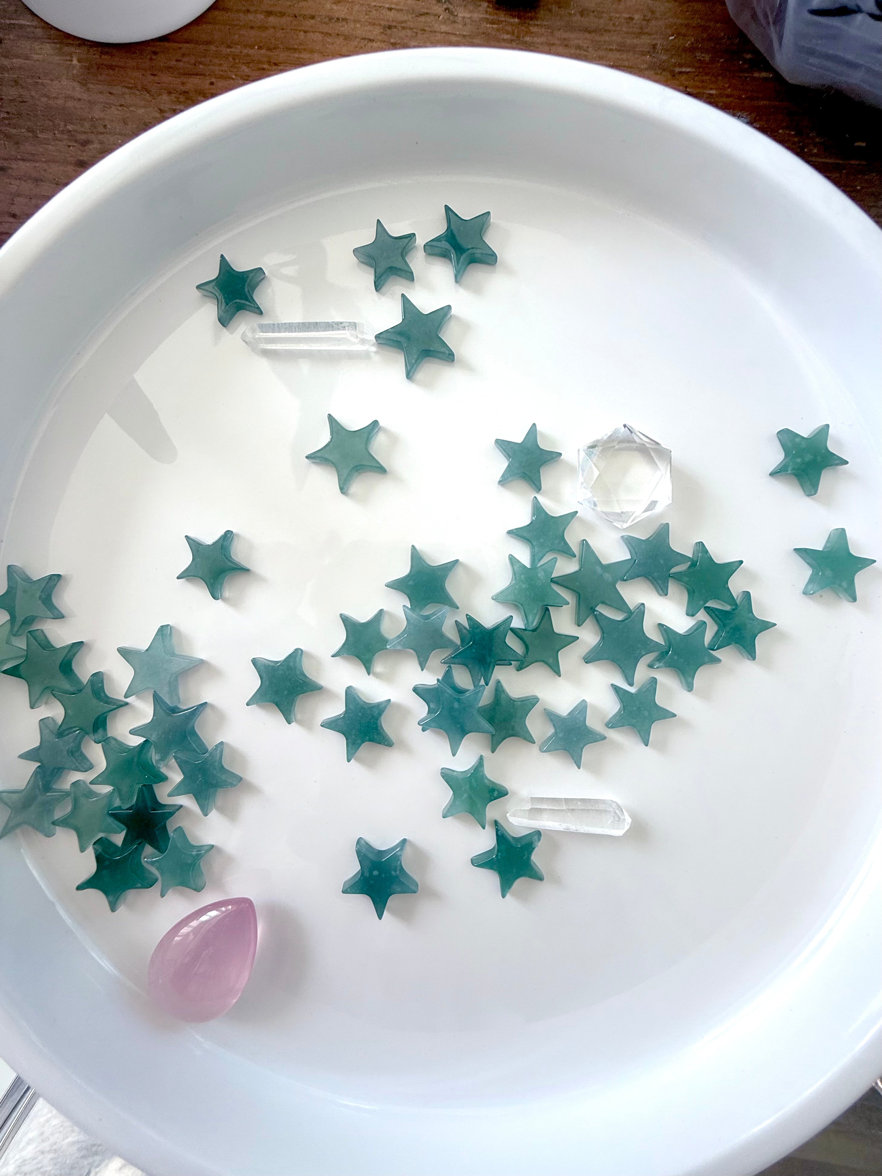 Blue Water Jadeite Stars photographed on a white plate in natural ambient light shown