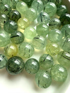 collection of prehnite mini crystal balls with epidote inclusions and varied translucency