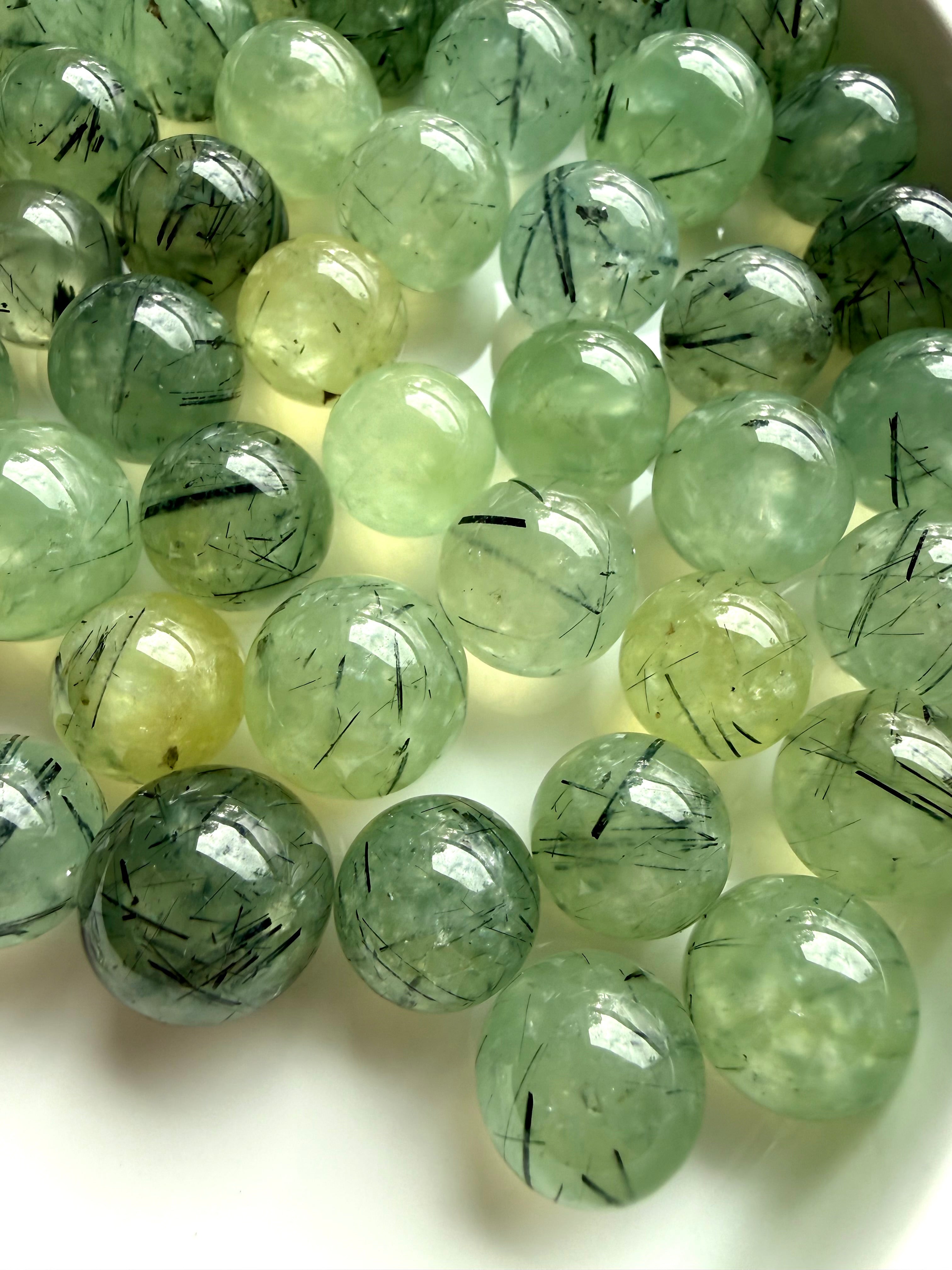 collection of prehnite mini crystal balls with epidote inclusions and varied translucency