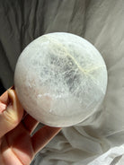 underside of selenite bowl showing circular base and natural stone variation, crystal dish for cleansing and charging