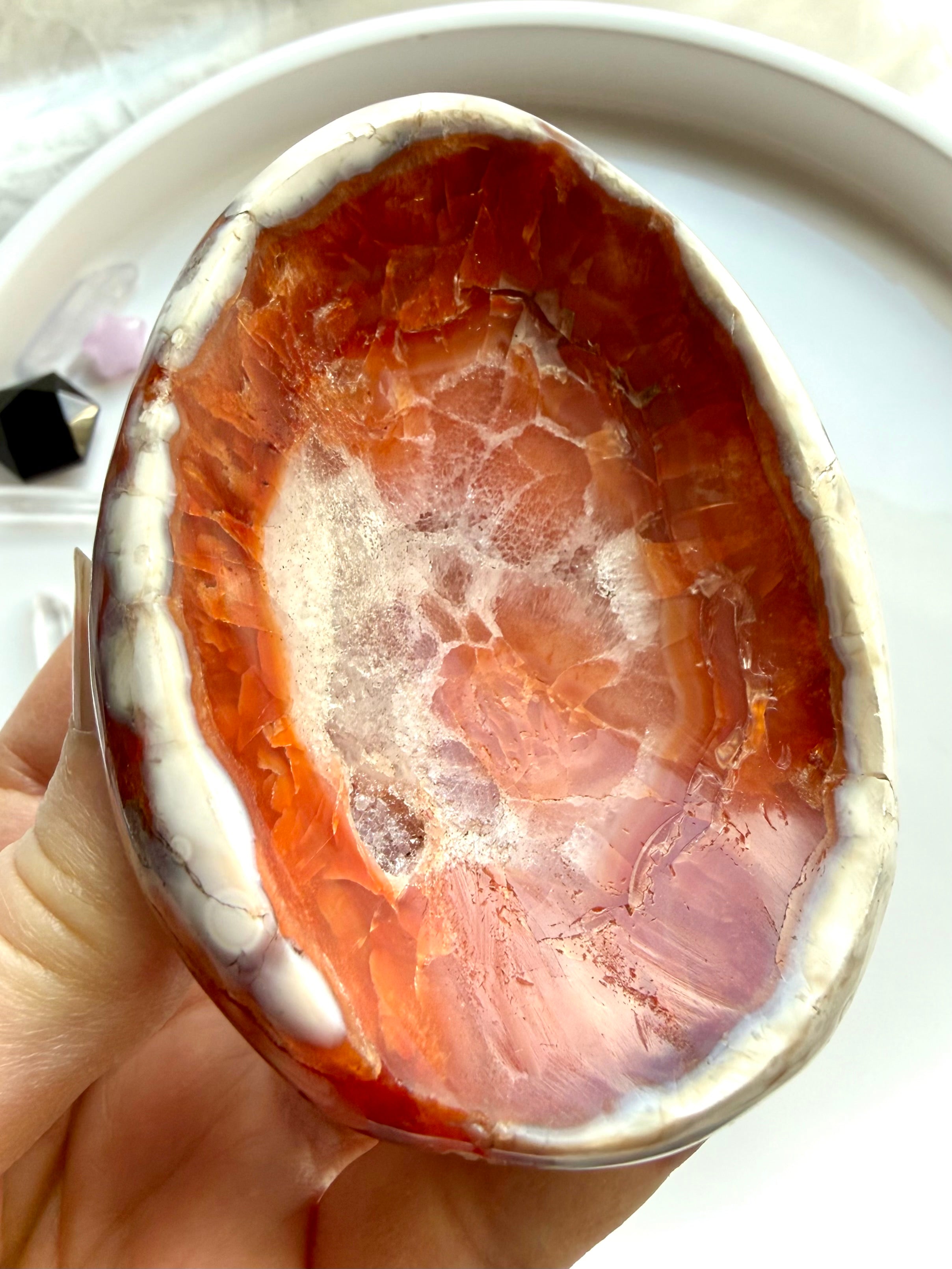 natural carnelian stone dish with white quartz druzy inclusions and polished finish in hand