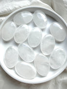 Polished Clear Quartz palm stones with translucent crystal, soft white internal patterns and natural variation
