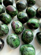 Close-up of Ruby Zoisite tumbled stones revealing natural ruby inclusions, vibrant green Zoisite and unique gemstone patterns