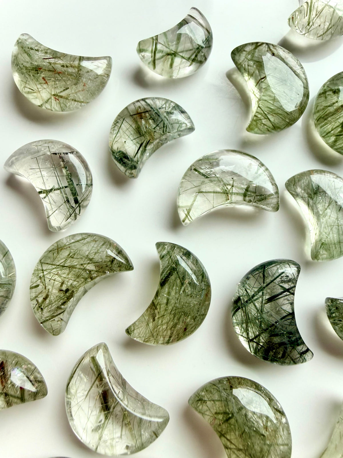 Green Tourmaline in Quartz crescent moons with varied green inclusions and natural patterns in polished crystal carvings