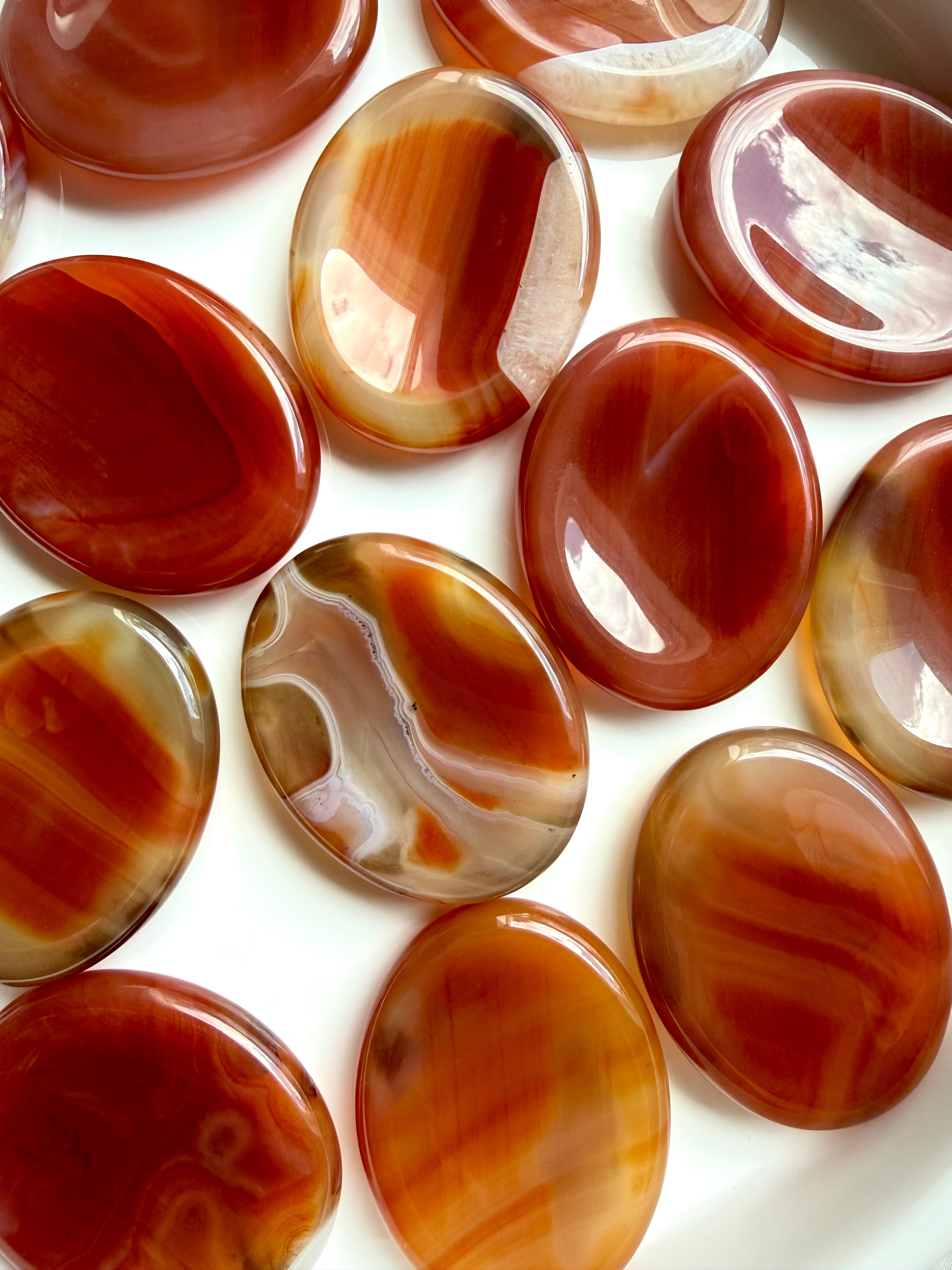 Carnelian Agate worry stones with rich red, orange and golden banded patterns for confidence, creativity and motivation