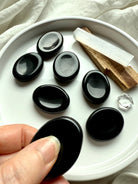 Polished Black Obsidian worry stones with selenite and palo santo – grounding crystal for protection, stress relief + root chakra healing