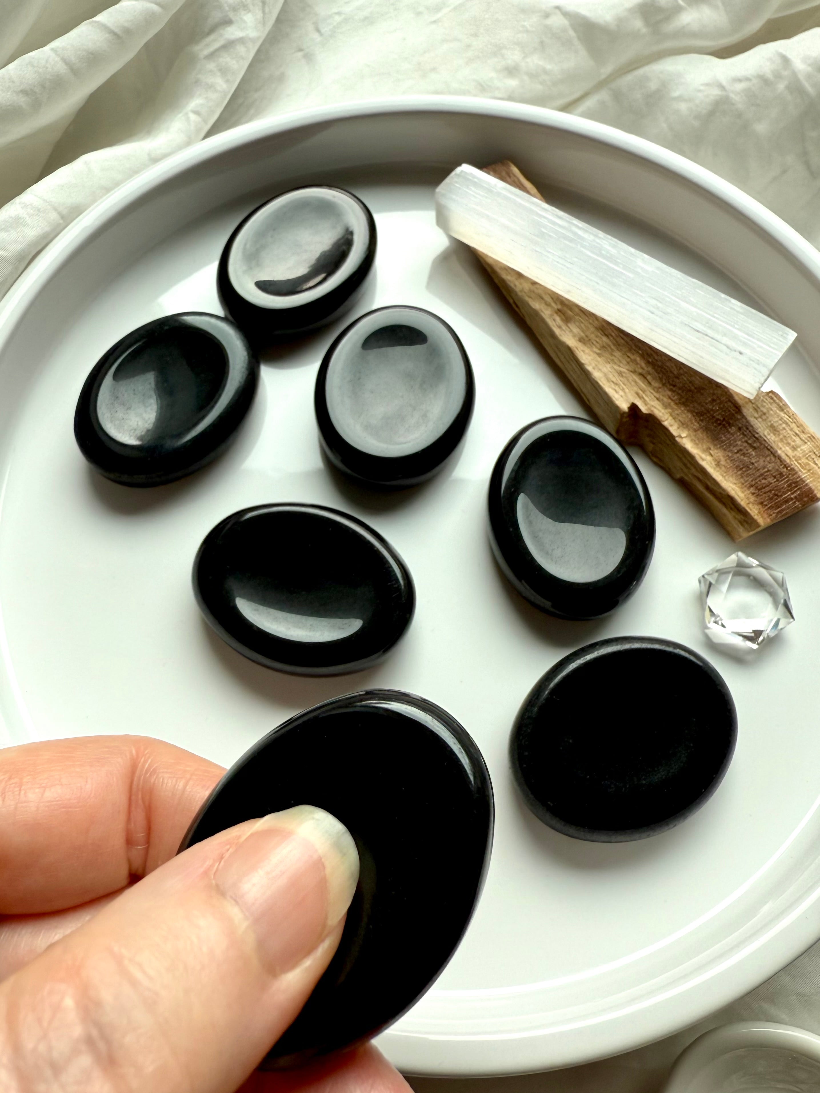 Polished Black Obsidian worry stones with selenite and palo santo – grounding crystal for protection, stress relief + root chakra healing