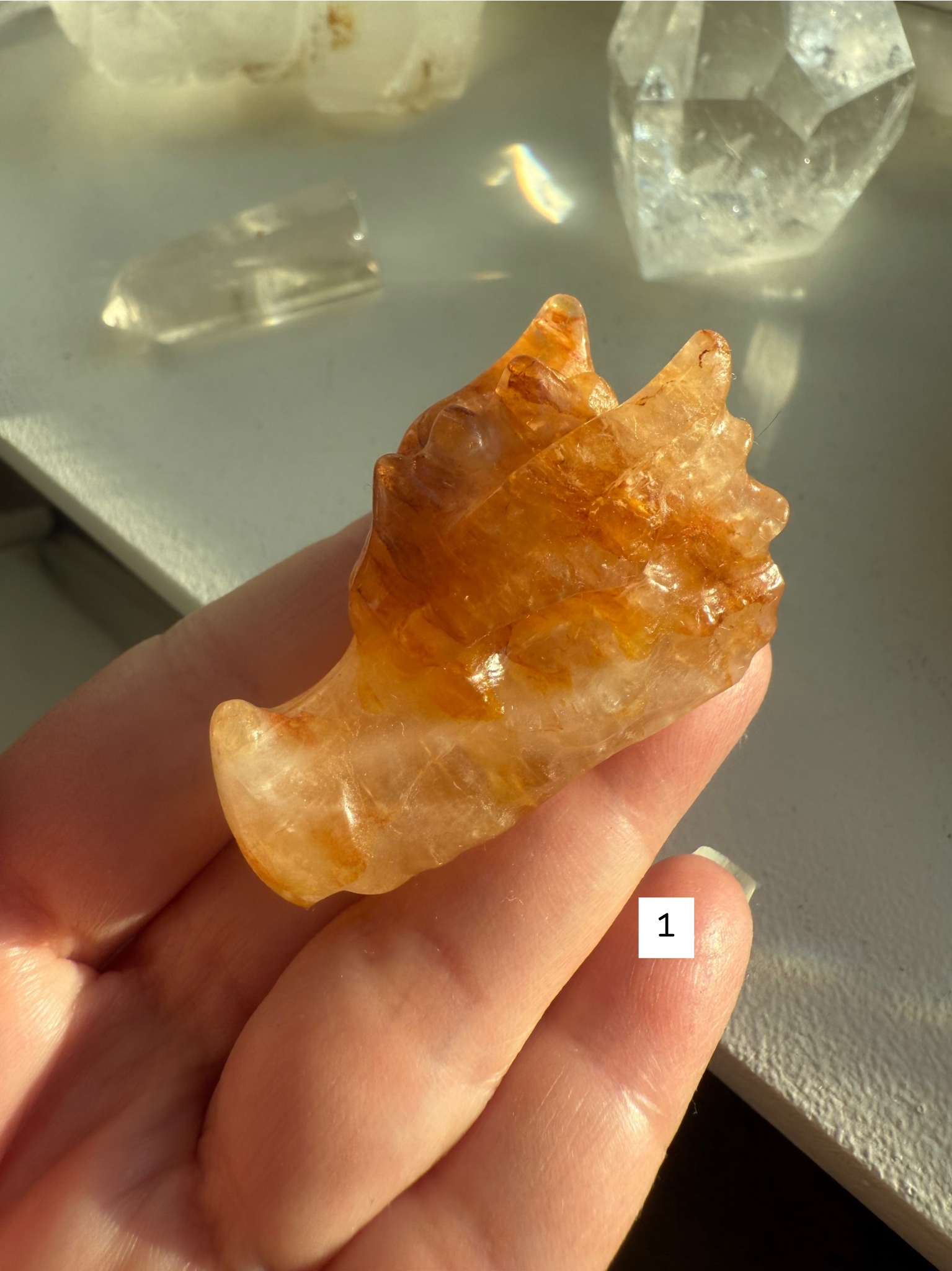Small Golden Healer Quartz dragon head in hand, showing natural honey and bronze tones — gemstone carving for meditation, Solar Plexus activation, and spiritual gifting.