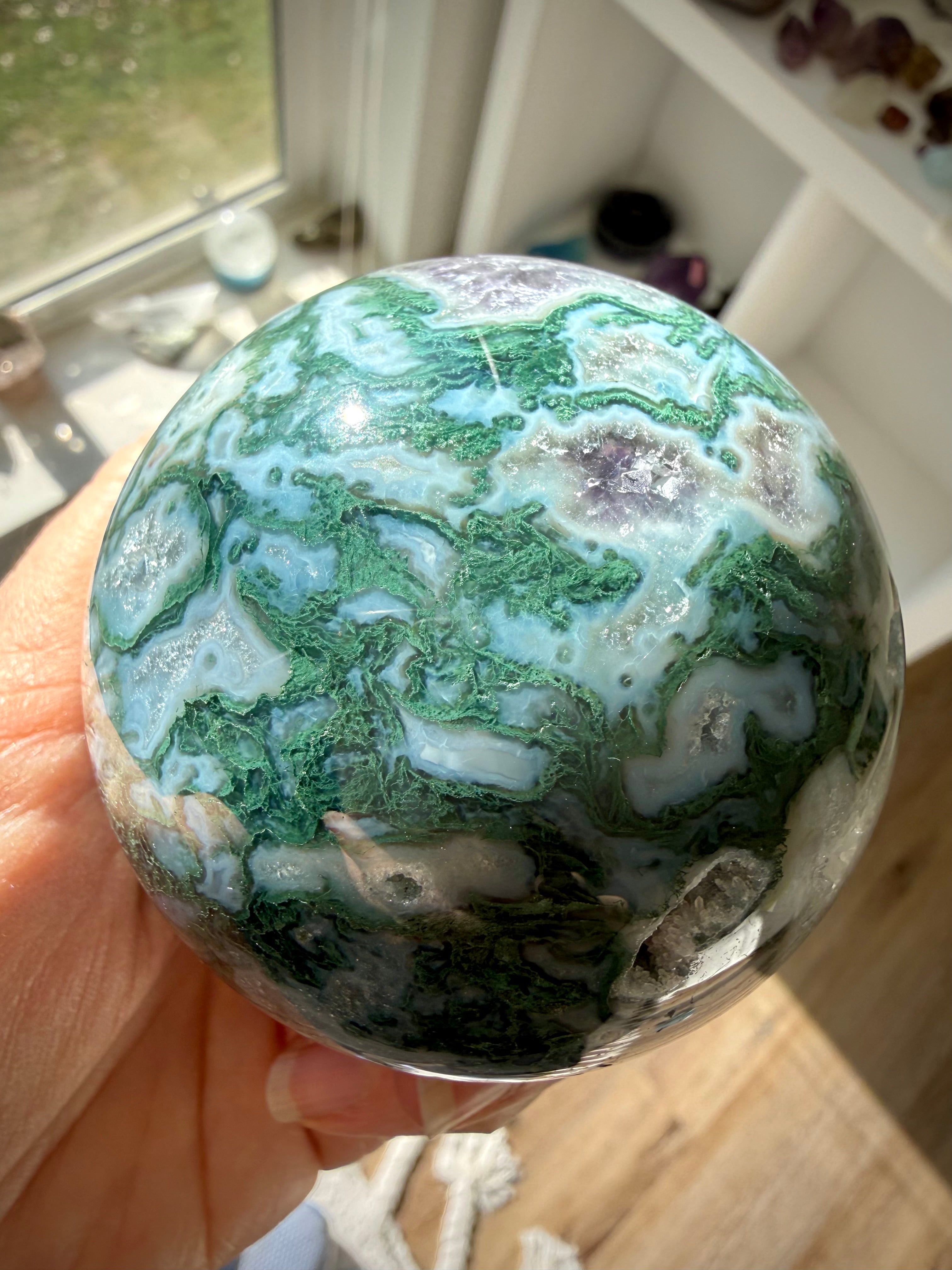 Moss Agate sphere crystal ball with unique green patterns, Quartz details, and Amethyst formations