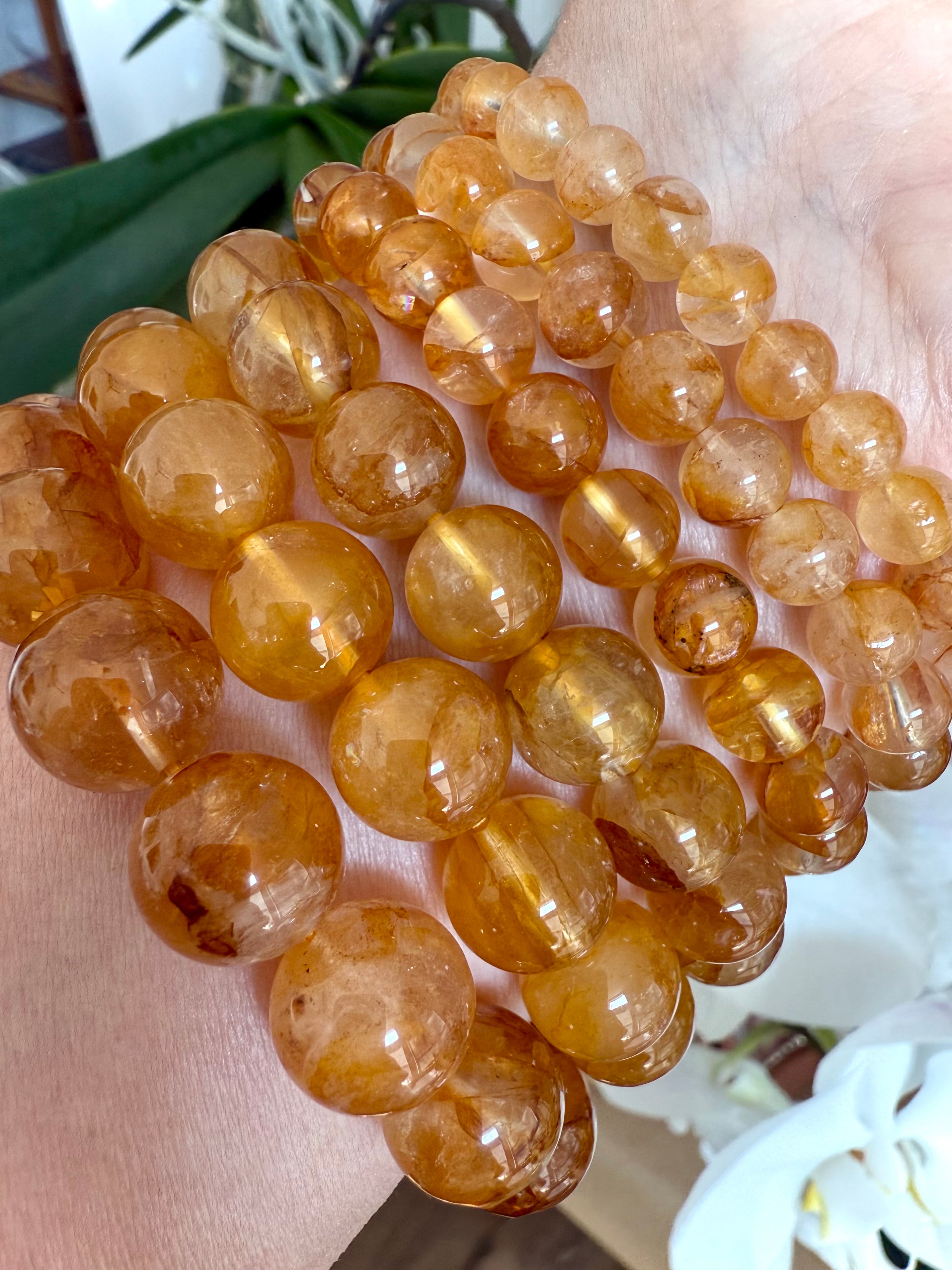 High-quality Golden Healer Quartz beads with rich golden inclusions and clear quartz transparency for solar plexus chakra healing.
