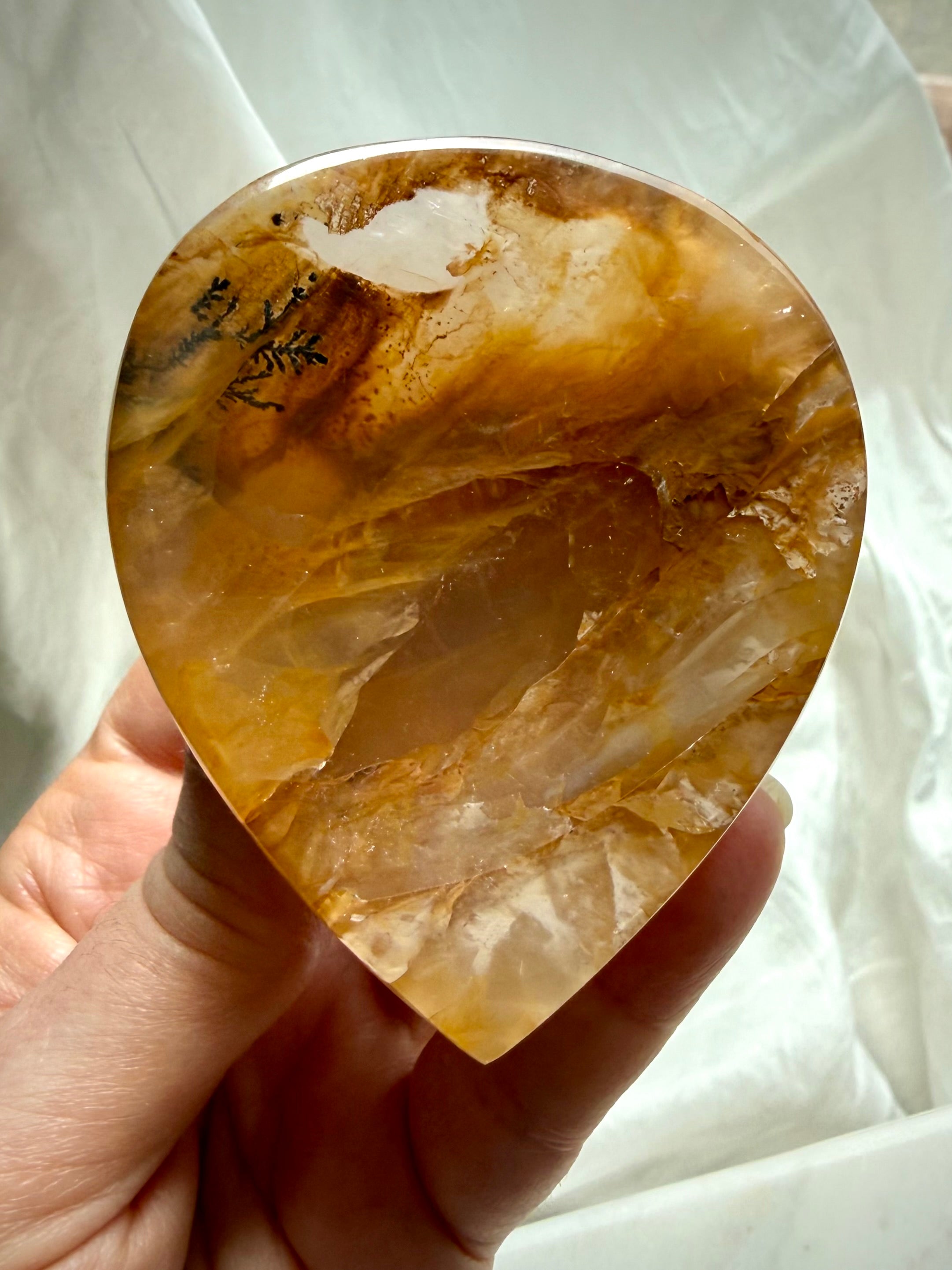 Handheld Golden Healer Quartz bowl showing luminous golden clarity and one of a kind dendritic pattern