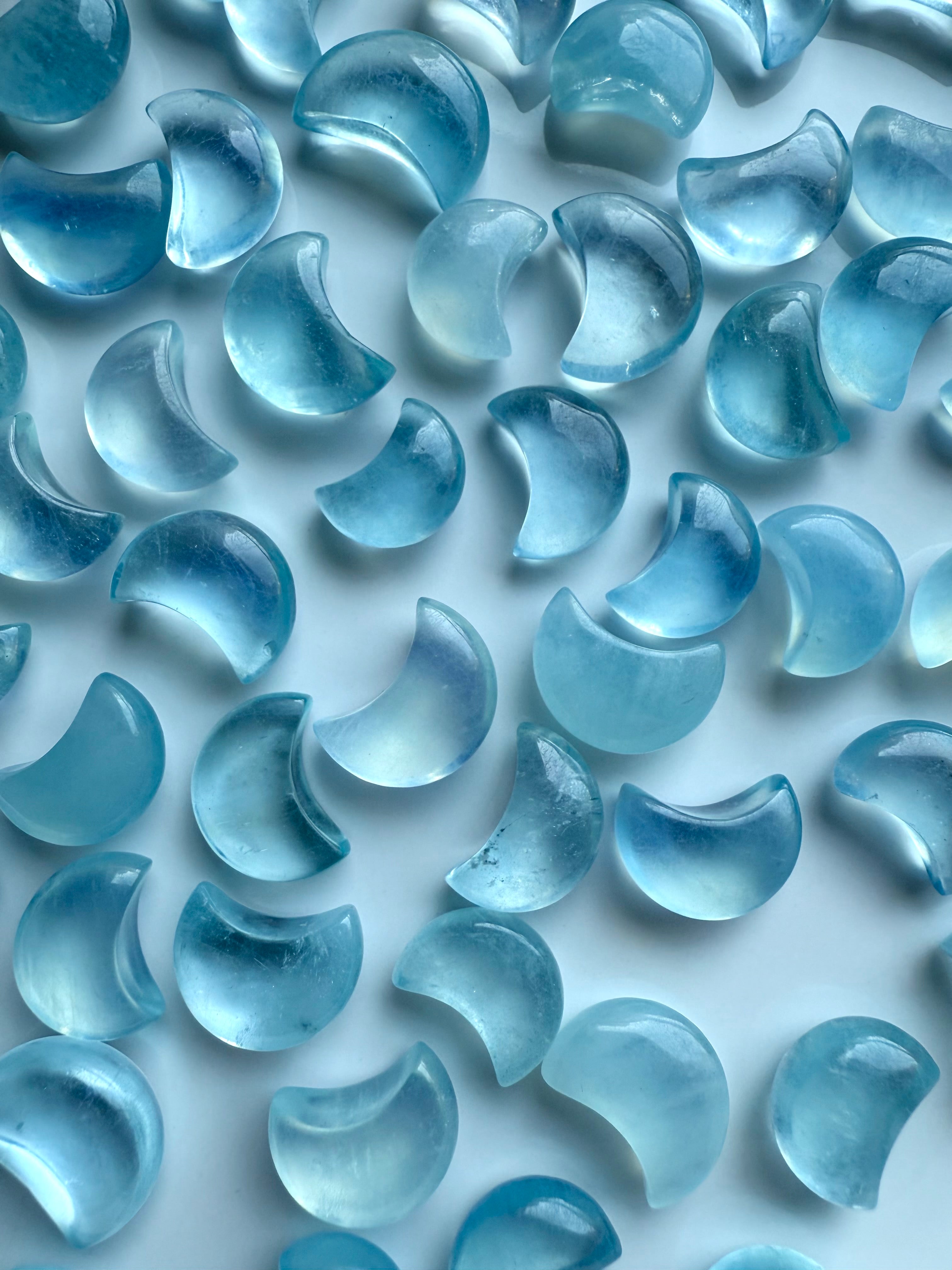 Closeup of polished Aquamarine Mini Moons showing high-clarity gemstone detail and color variation — ideal for mini altars and pocket talismans