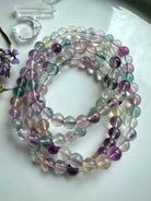 Group of mixed color fluorite crystal bracelets highlighting clarity, polish, and natural gemstone translucence