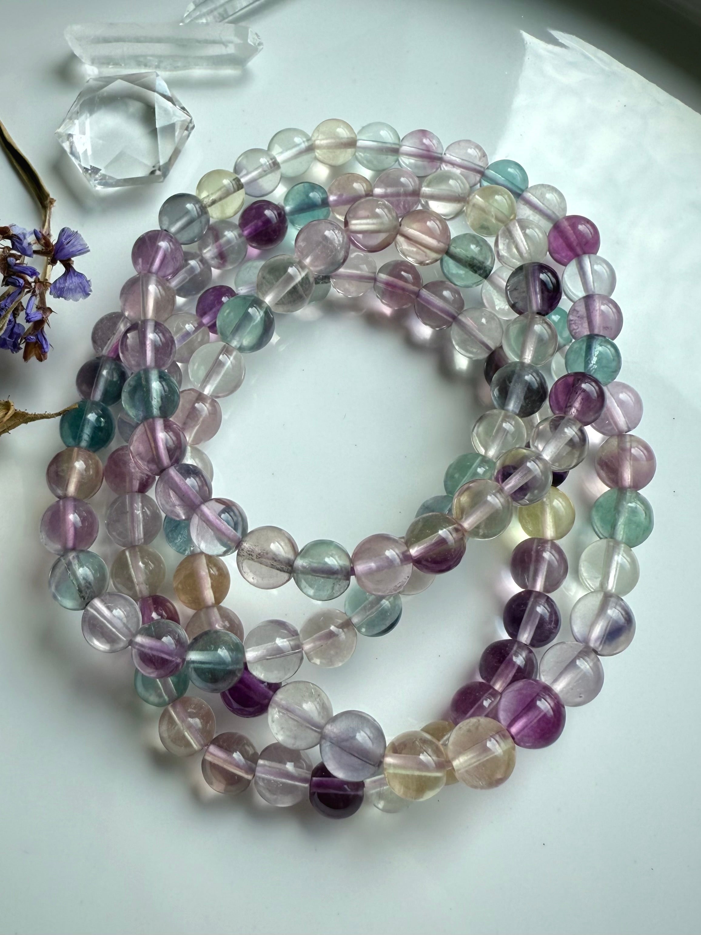 Group of mixed color fluorite crystal bracelets highlighting clarity, polish, and natural gemstone translucence