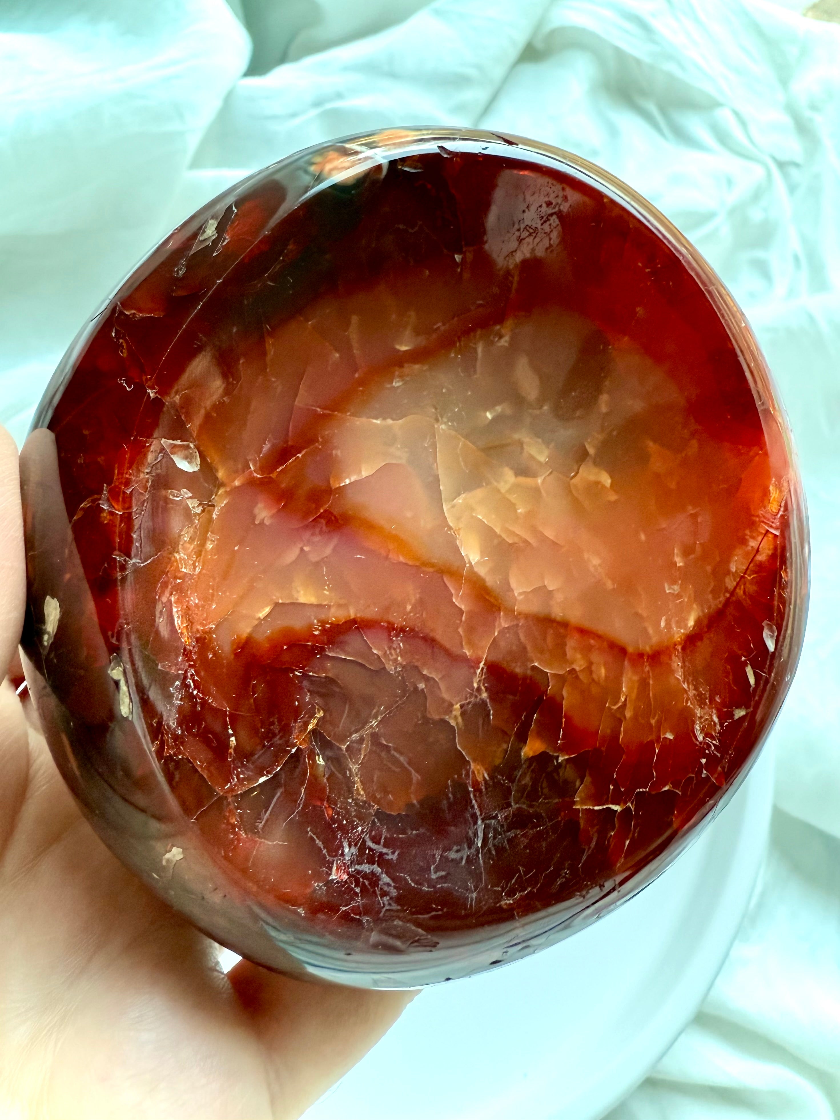 Close-up of fiery orange Carnelian bowl showing inner bands, inclusions, and rich natural color – hand-carved gemstone altar bowl