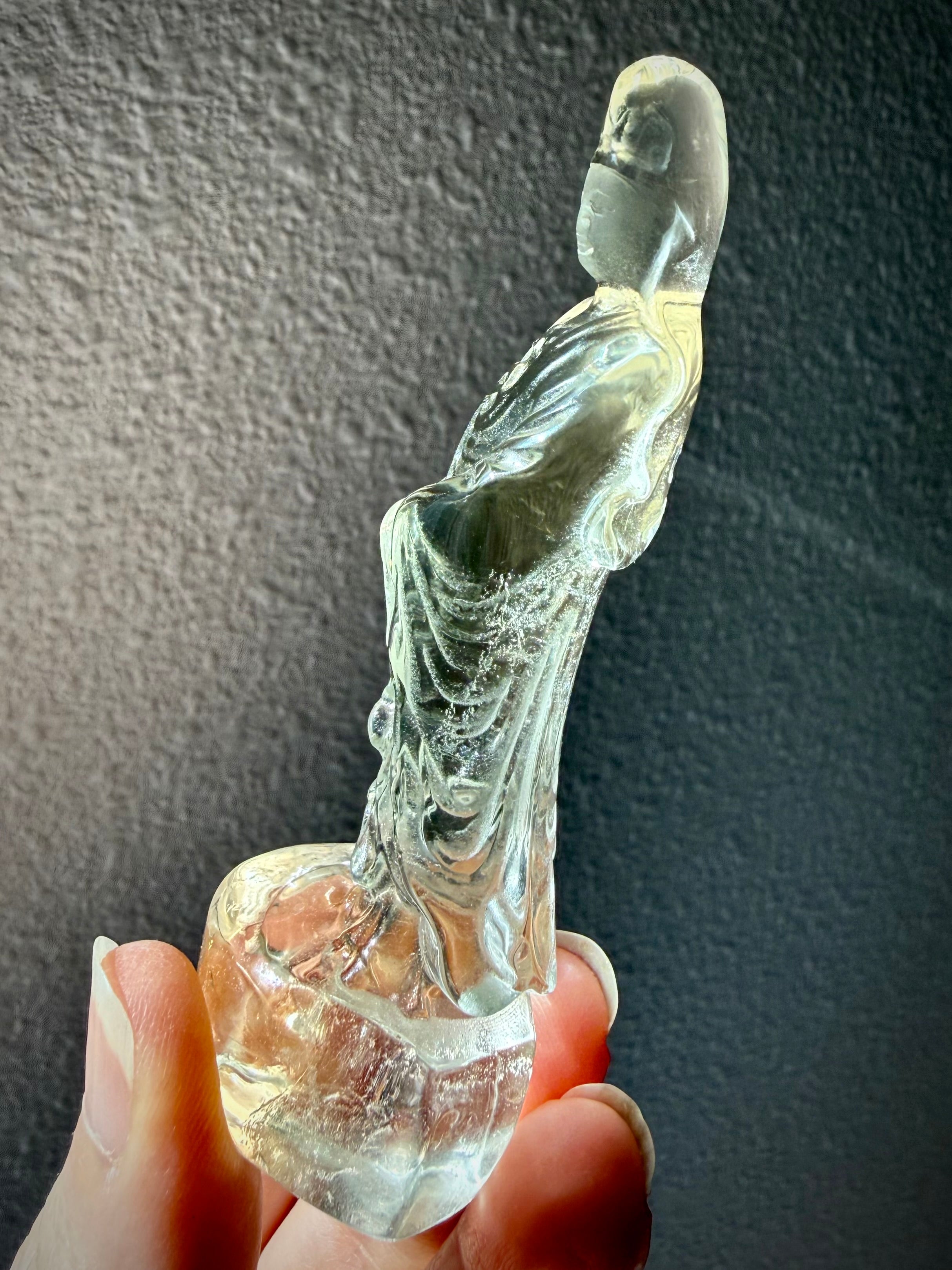 side view of Citrine Quan Yin crystal goddess statue with soft golden color and polished finish 