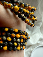Bumblebee jasper bracelets stacked on wrist, vivid golden yellow with earthy black matrix for grounding and personal empowerment