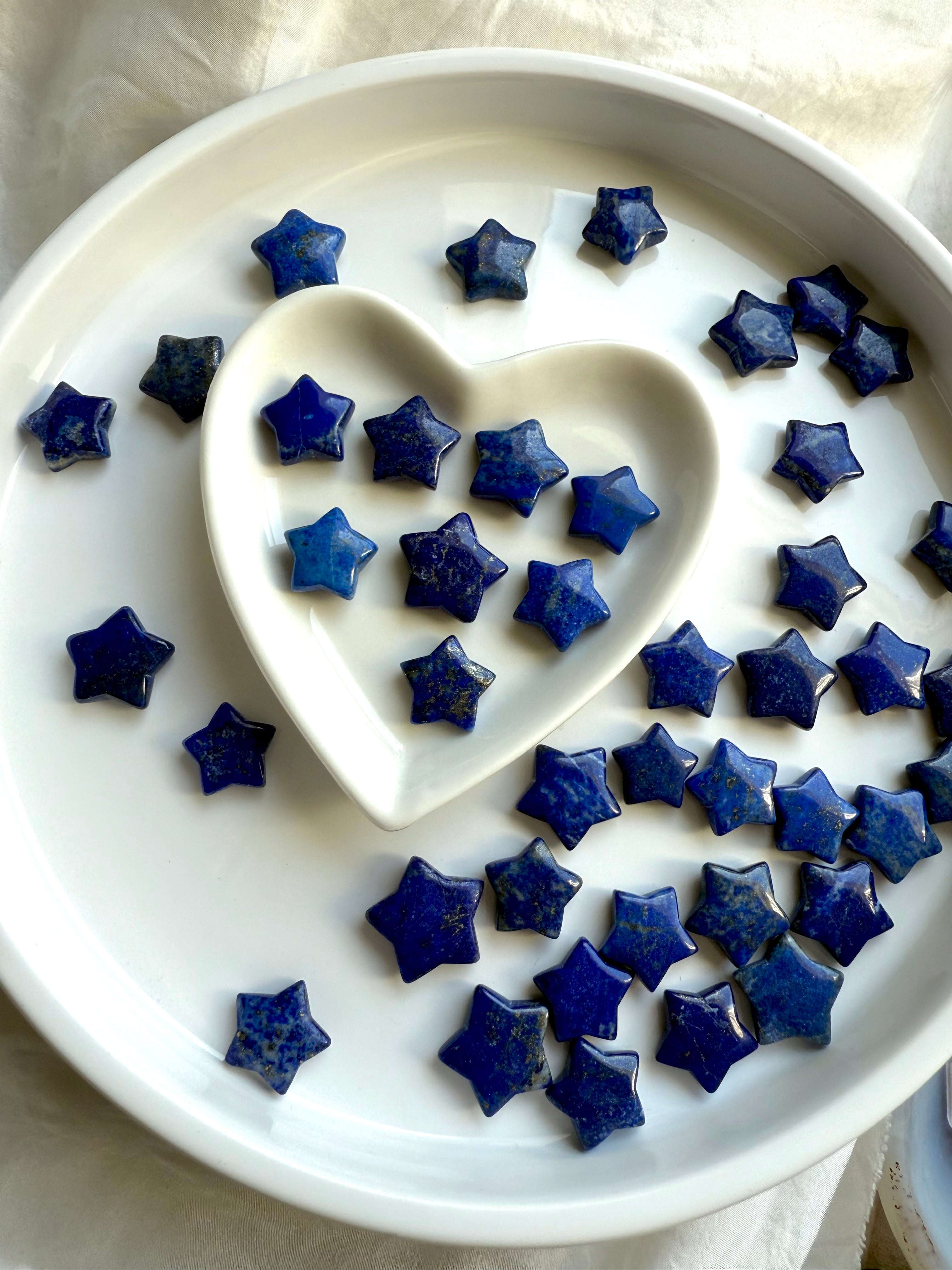 Mini blue Lapis Lazuli star carvings with glossy finish and celestial patterns