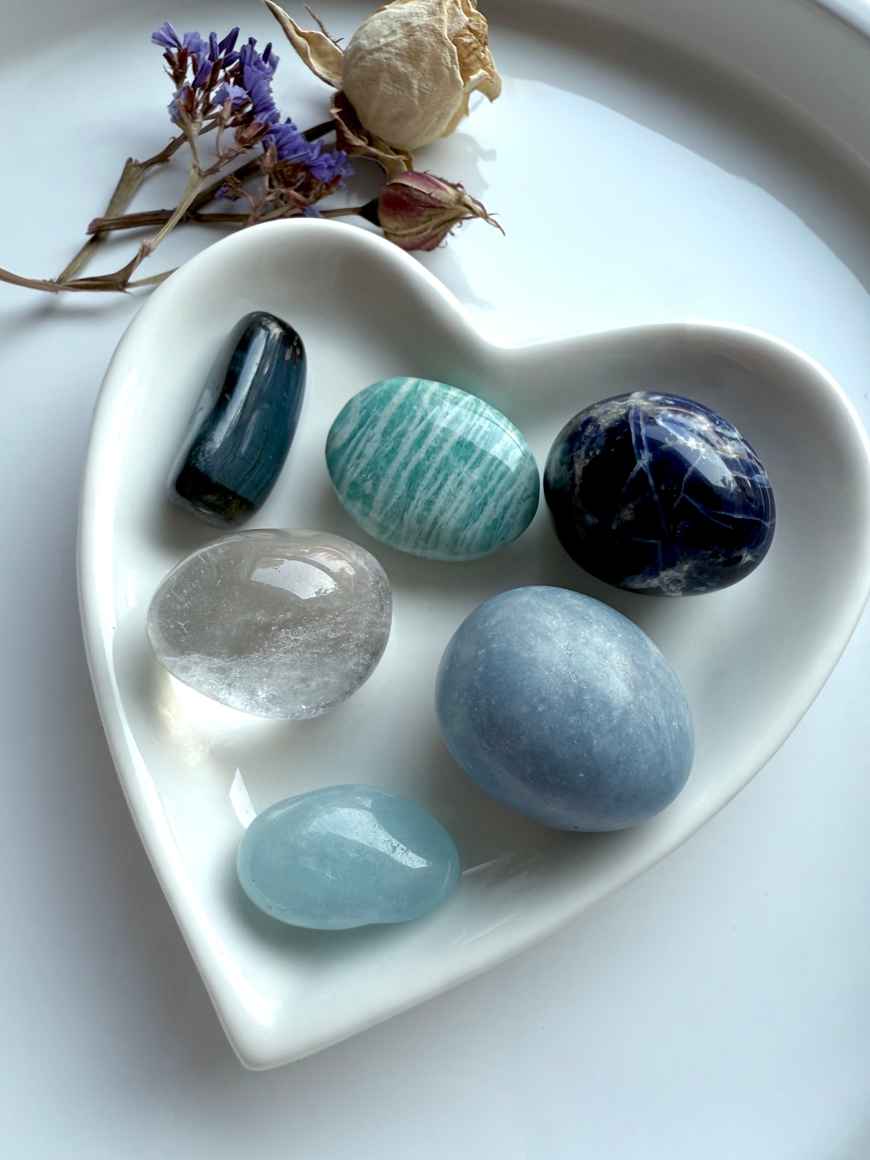 Throat Chakra Crystal Set in white heart-shaped dish with dried flowers — six healing stones for communication and creativity