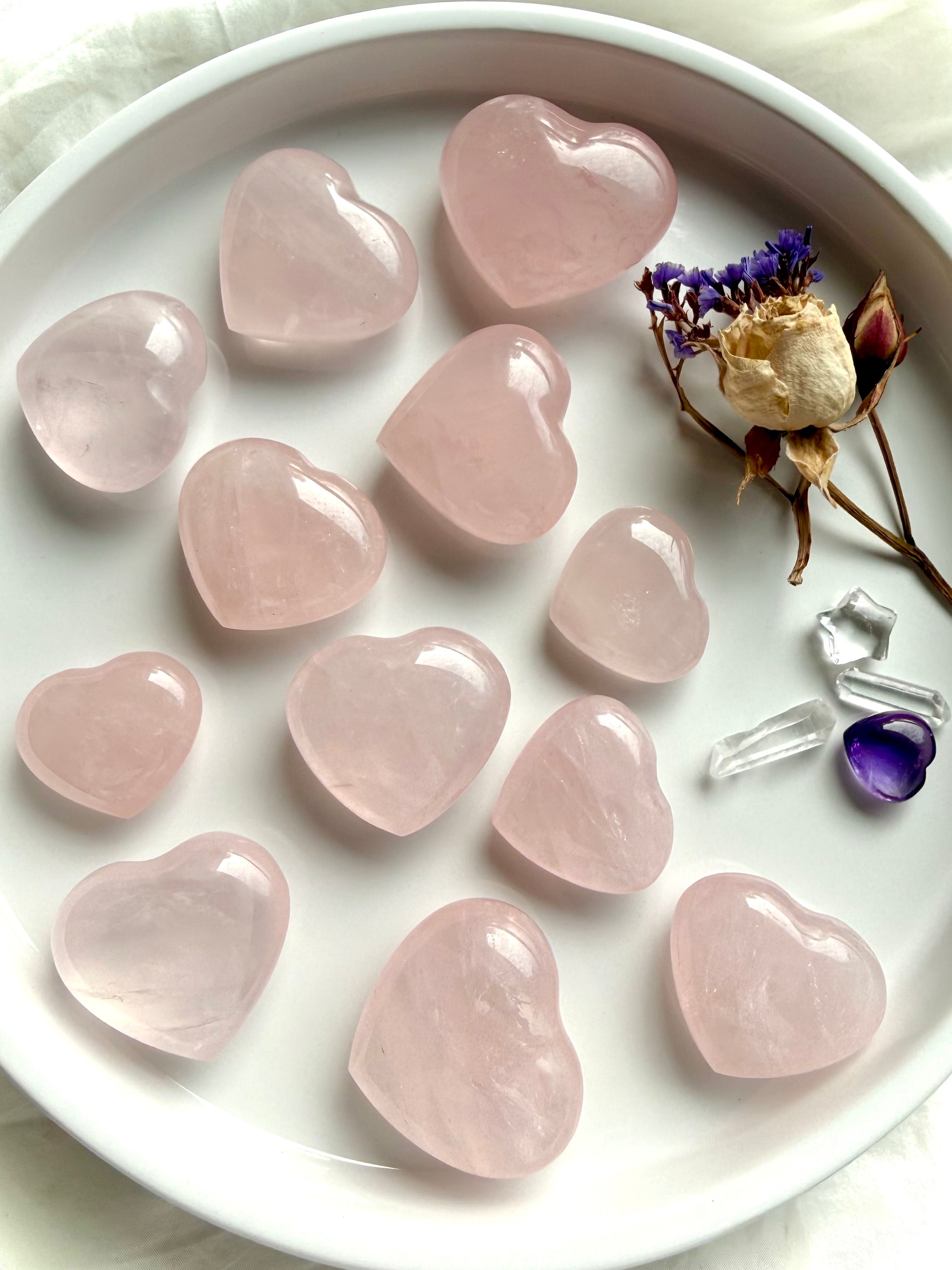 Rose quartz hearts with dried flowers and clear quartz points, crystal hearts for love, balance, and gentle energy