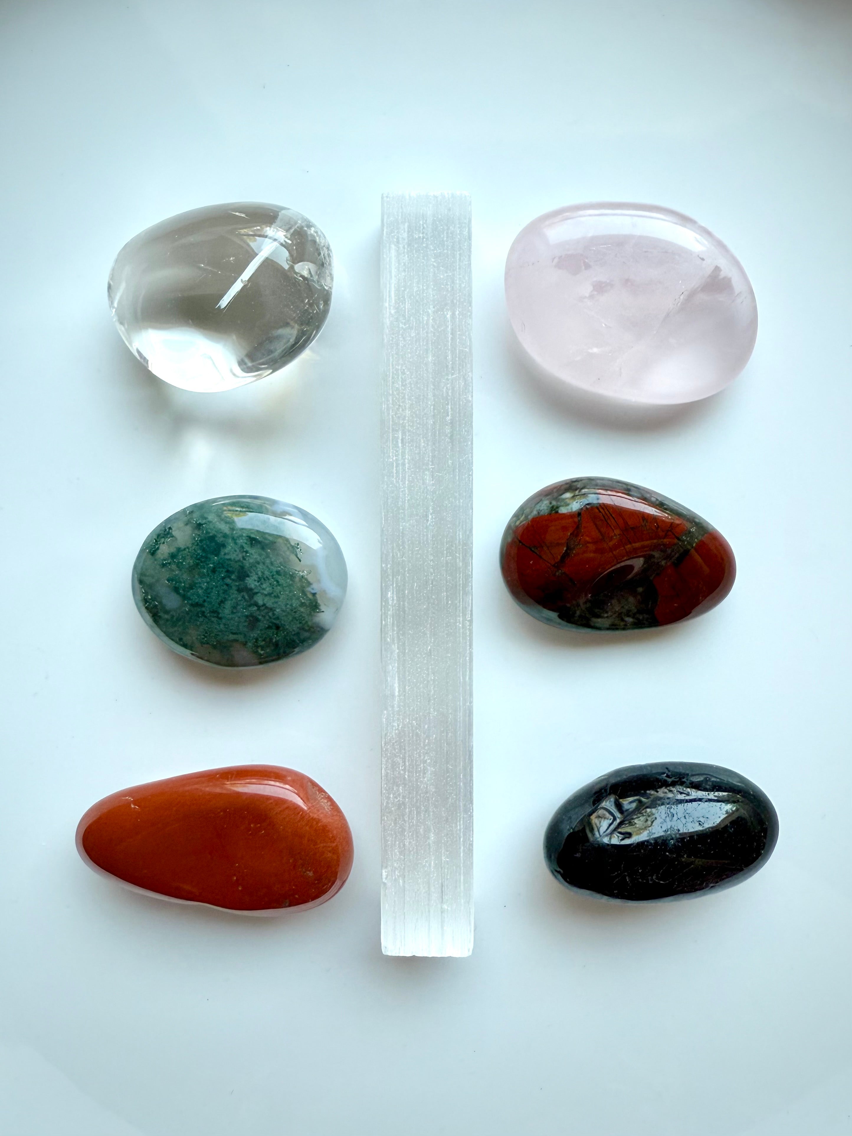 Get Well healing crystals arranged in a grid layout, featuring Rose Quartz, Selenite, Bloodstone, & more