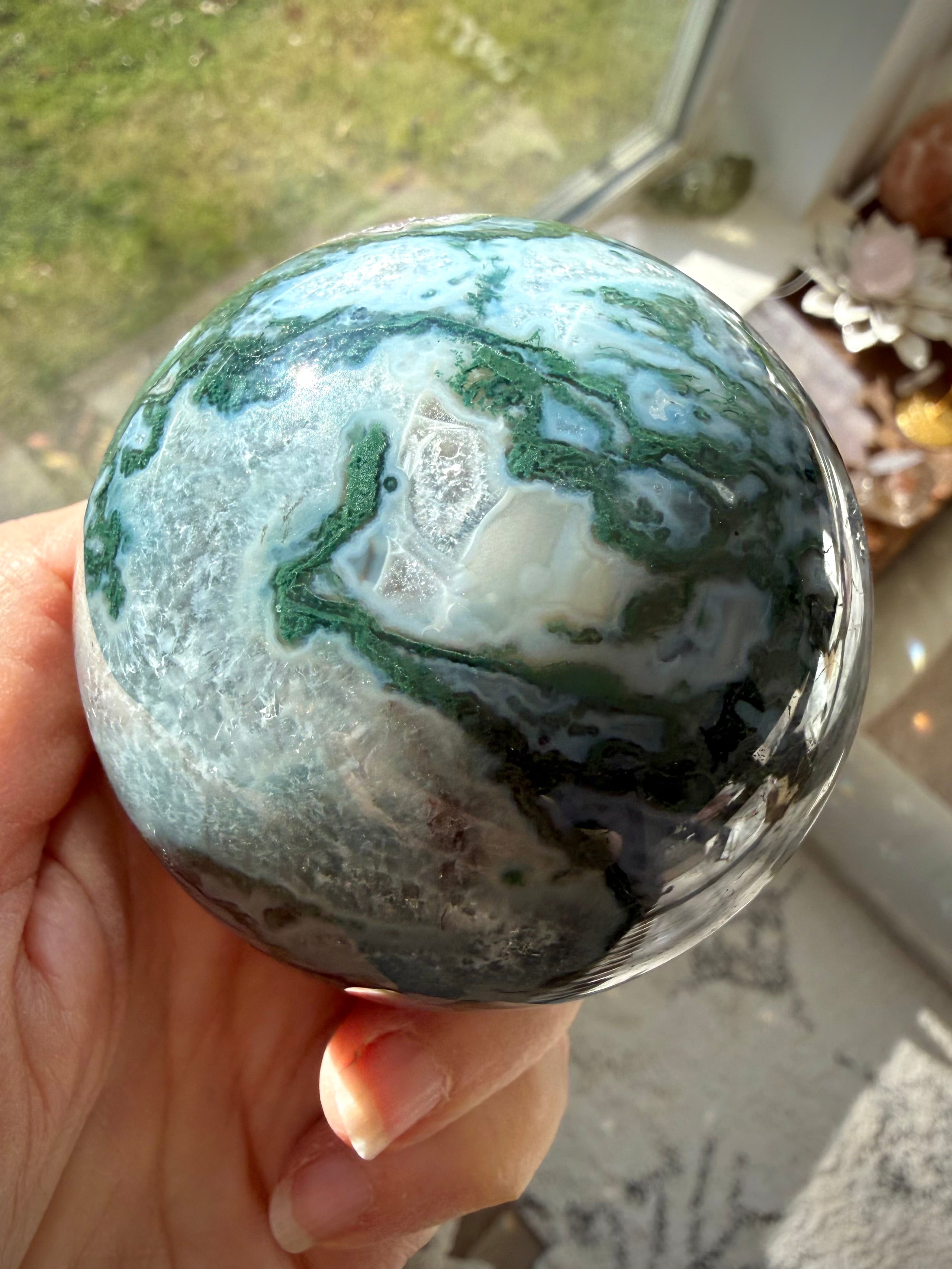 Moss Agate sphere with natural Quartz inclusions, green mineral patterns, and unique crystal formations