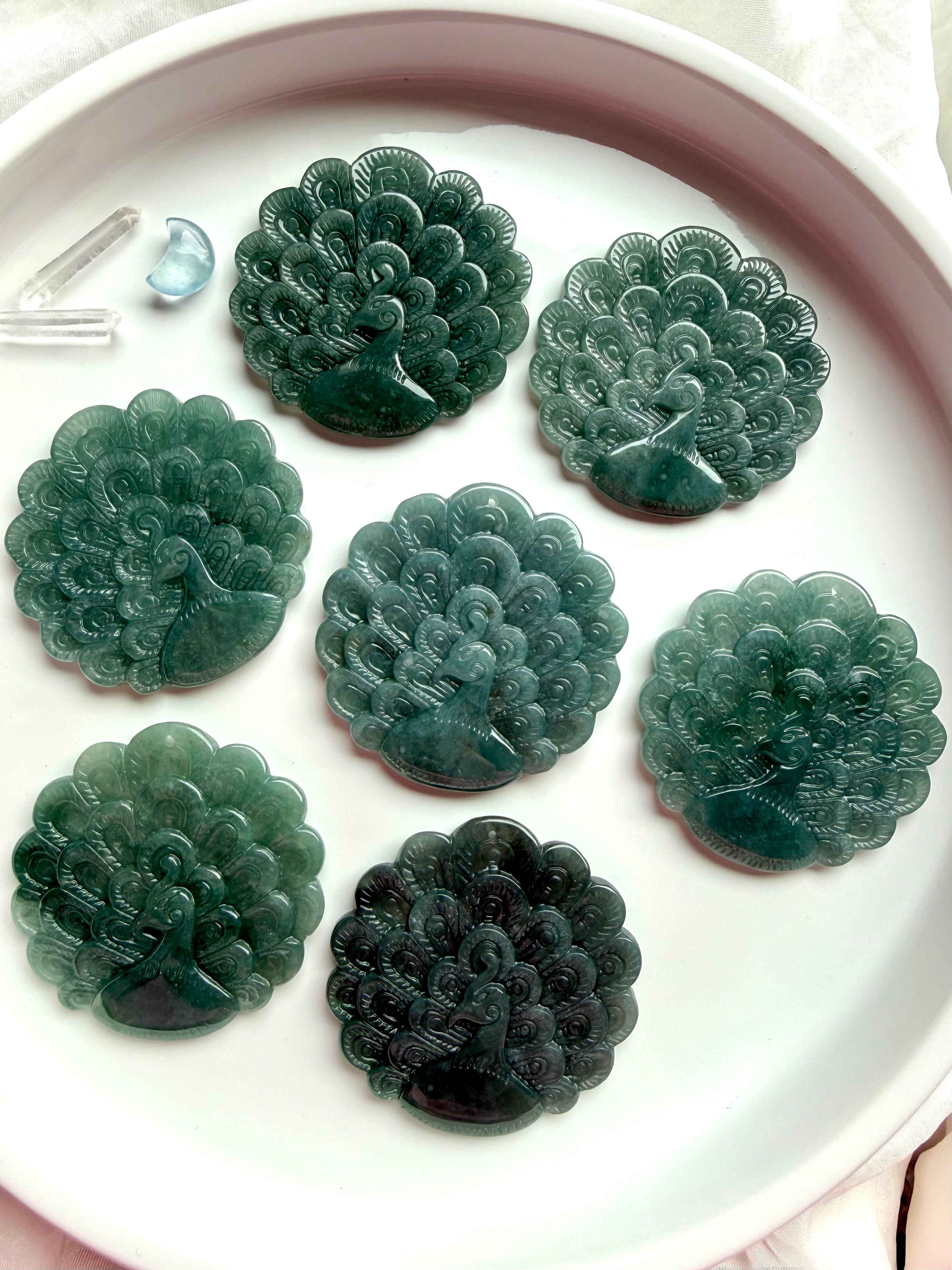 Collection of hand-carved Blue Water Jade peacock medallions in assorted natural tones