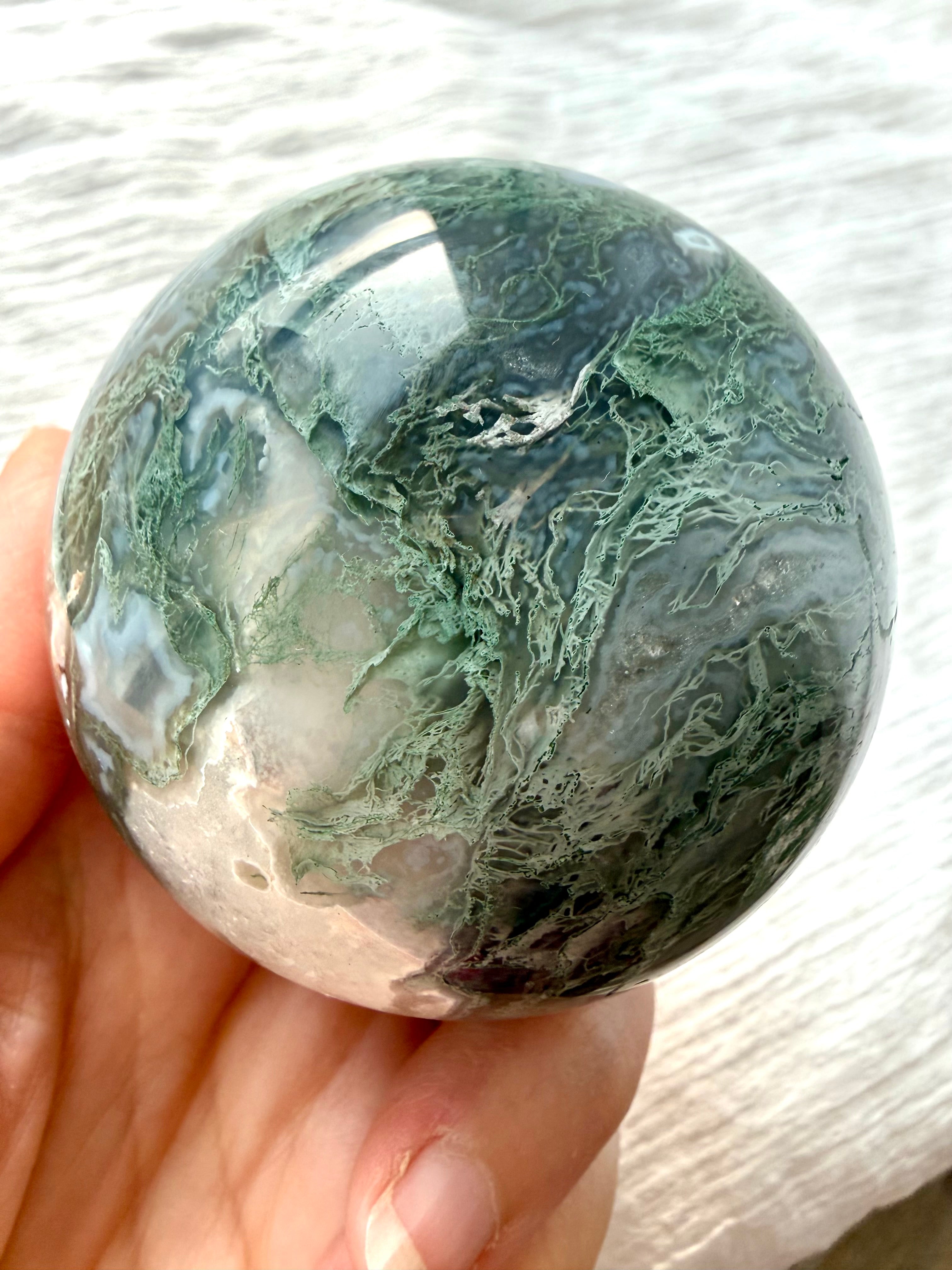 Polished Moss Agate sphere with feathery green dendrites and translucent gray chalcedony