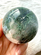 Polished Moss Agate sphere with feathery green dendrites and translucent gray chalcedony